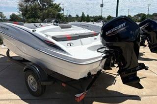 2026 Tahoe T16 boat with Mercury engine on a trailer, parked outdoors.