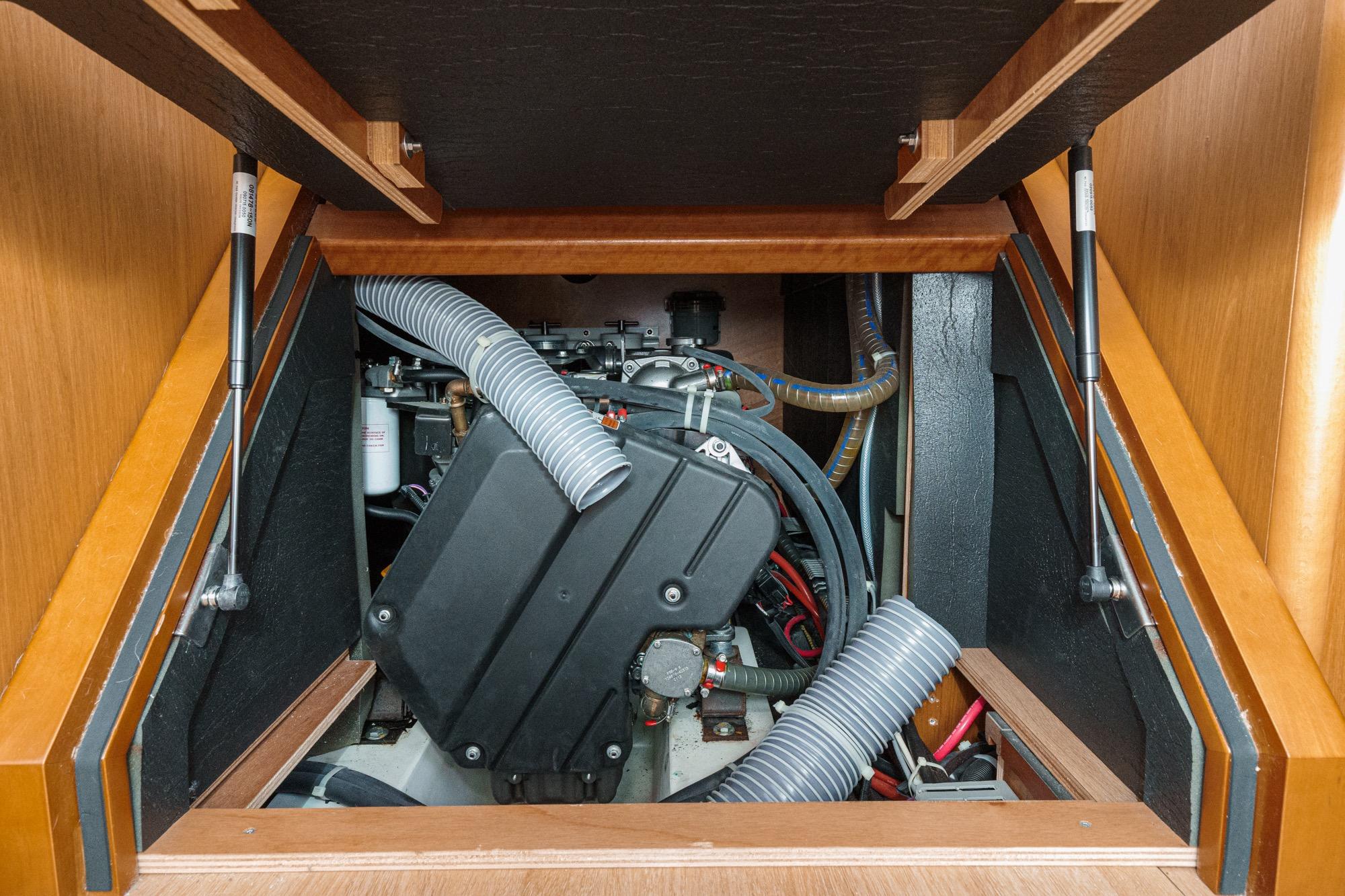 Engine compartment of a 2017 Beneteau Sense 50 sailboat, showcasing mechanical components.