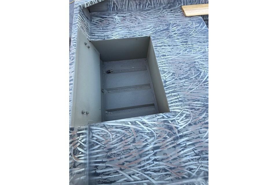 2026 Tracker Grizzly 15 Jon boat interior with open storage compartment.