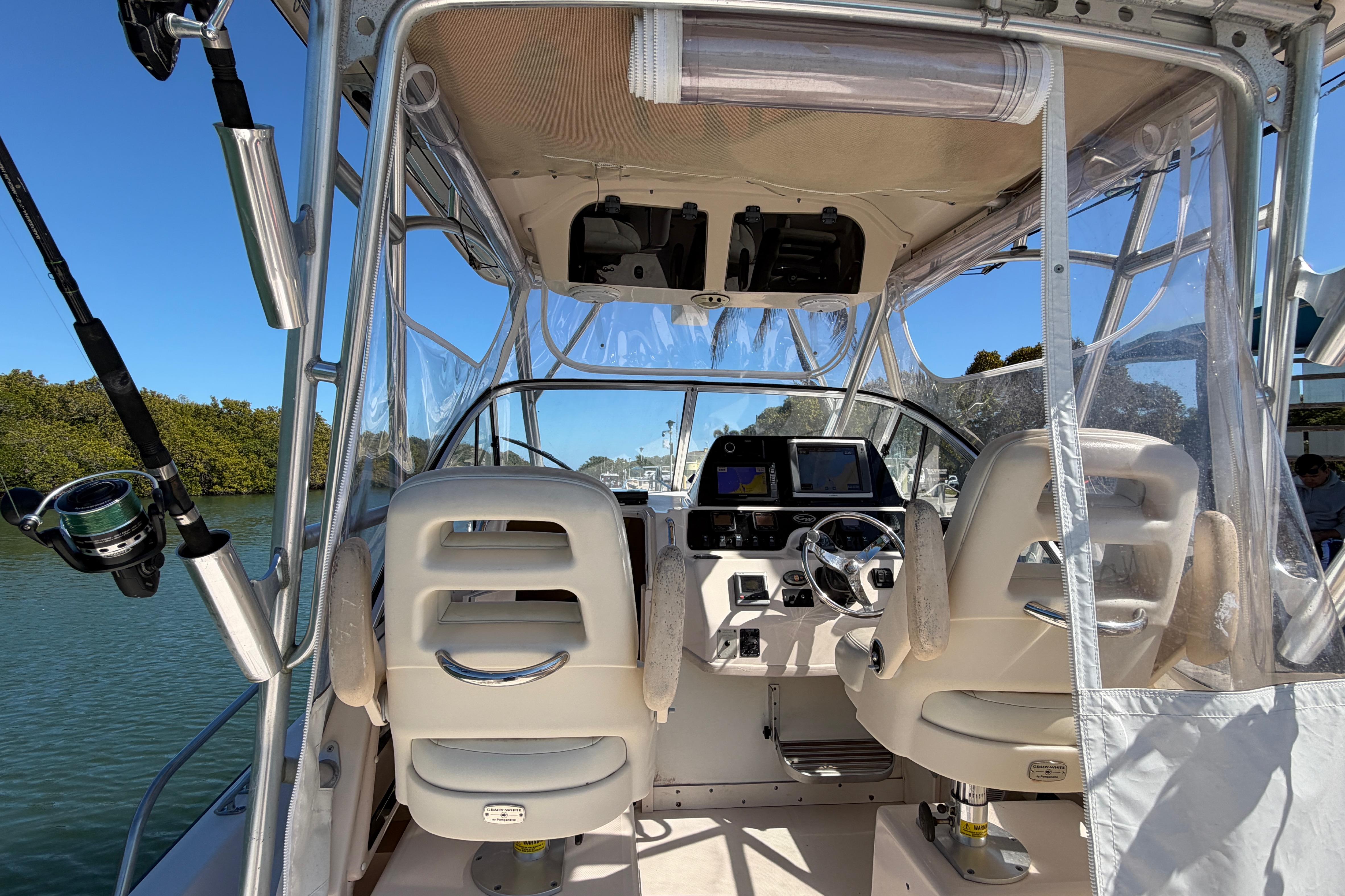 2006 Grady-White Sailfish 282 boat interior with helm, seats, and fishing rod.
