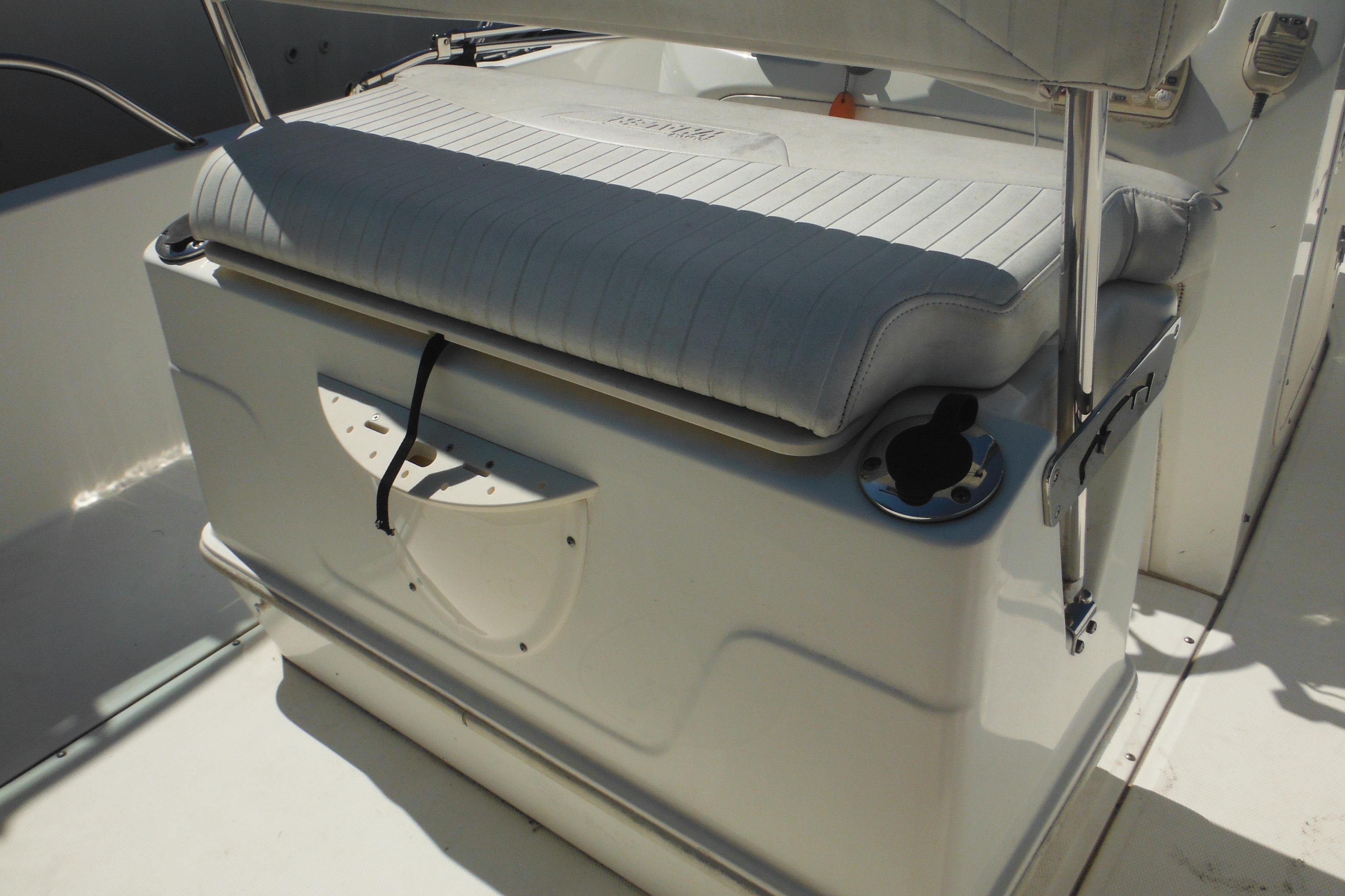 2009 Boston Whaler 200 Dauntless boat seat with storage and cup holder.