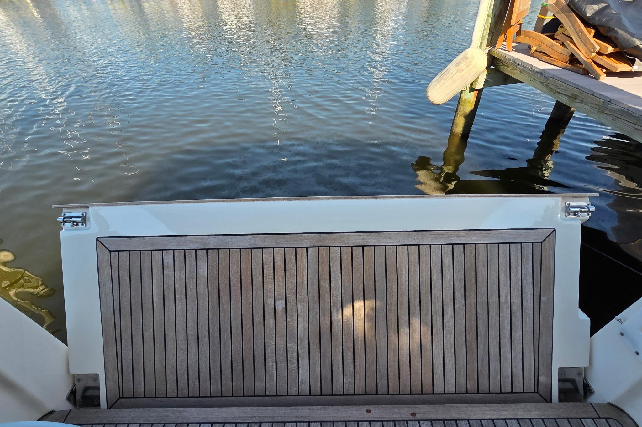 2023 Greenline 40 yacht swim platform by the water, dockside view.