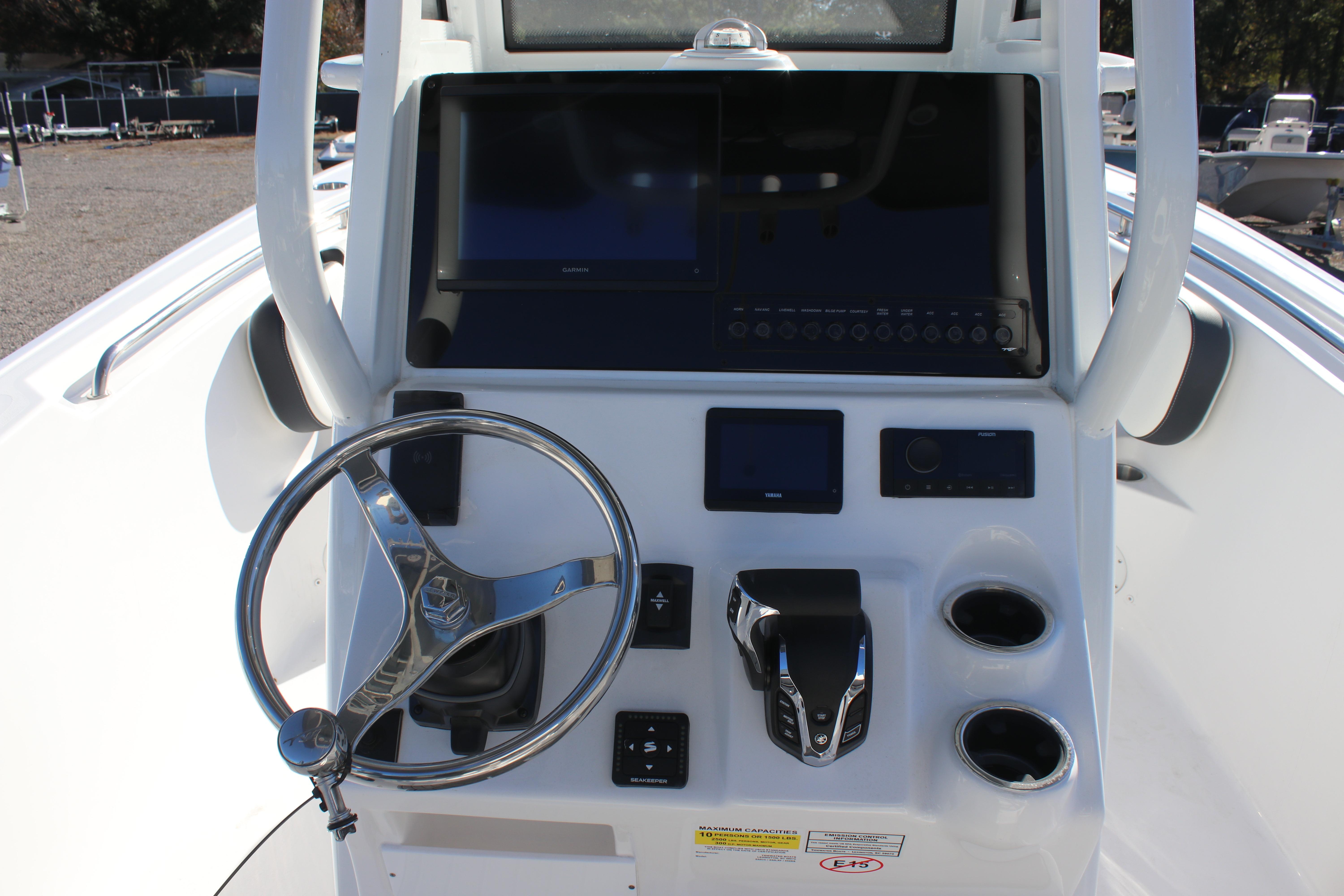 2026 Tidewater 232 CC Adventure boat console with steering wheel and electronic controls.