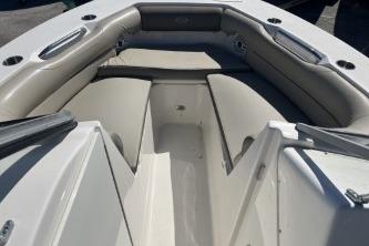 2022 Key West 239 DFS boat interior with cushioned seating and storage compartments.