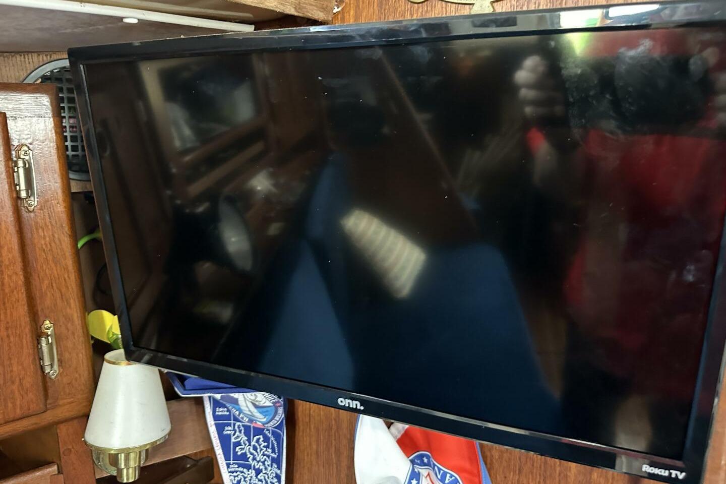 TV mounted on wooden interior of 1979 Hughes 3910 boat.