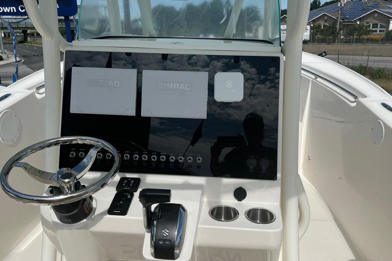 2023 Sea Born SX239 Offshore boat dashboard with Simrad displays and steering wheel.