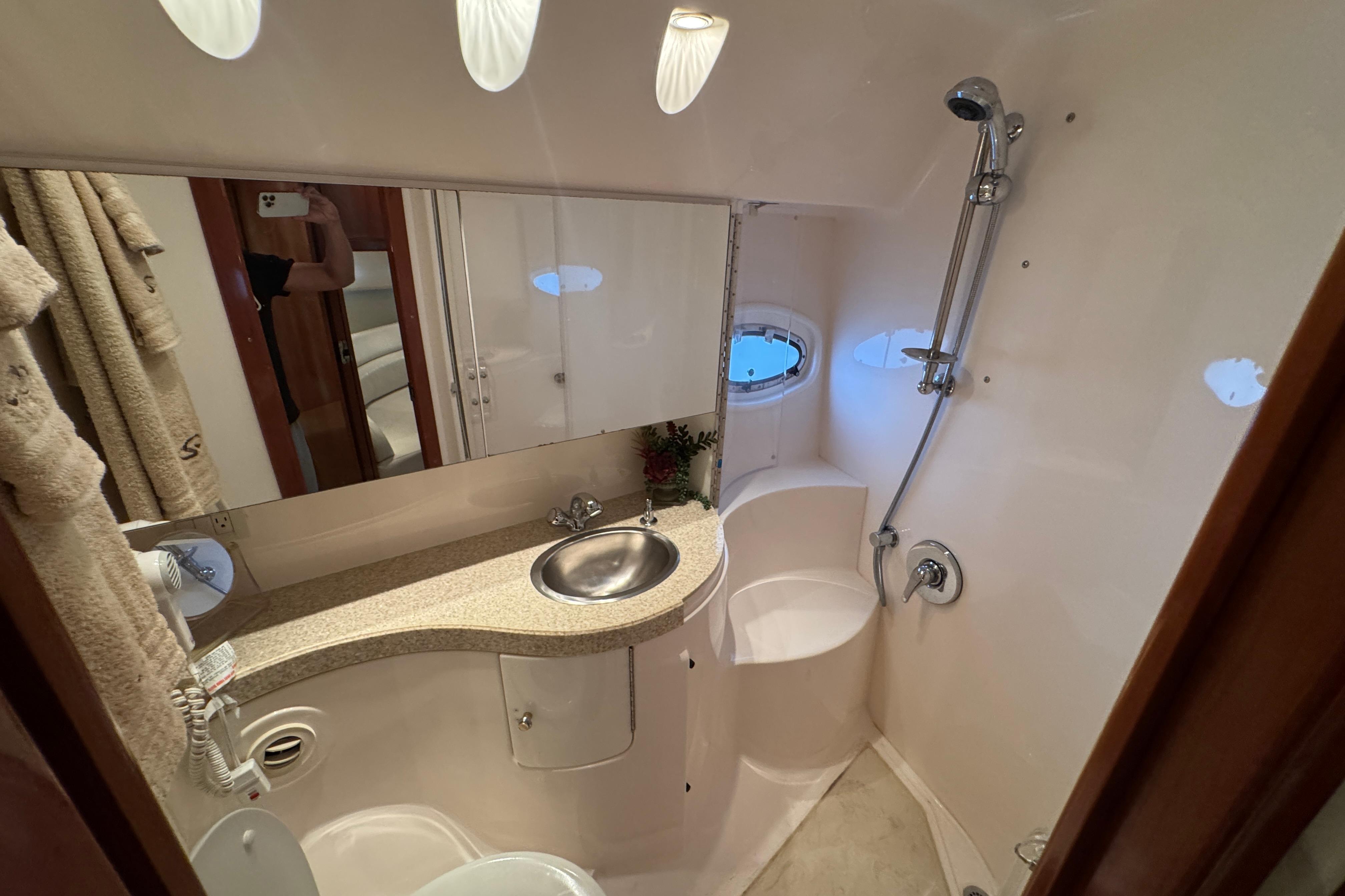 Luxurious bathroom in 2005 Regal Commodore 4260 yacht with shower and vanity.