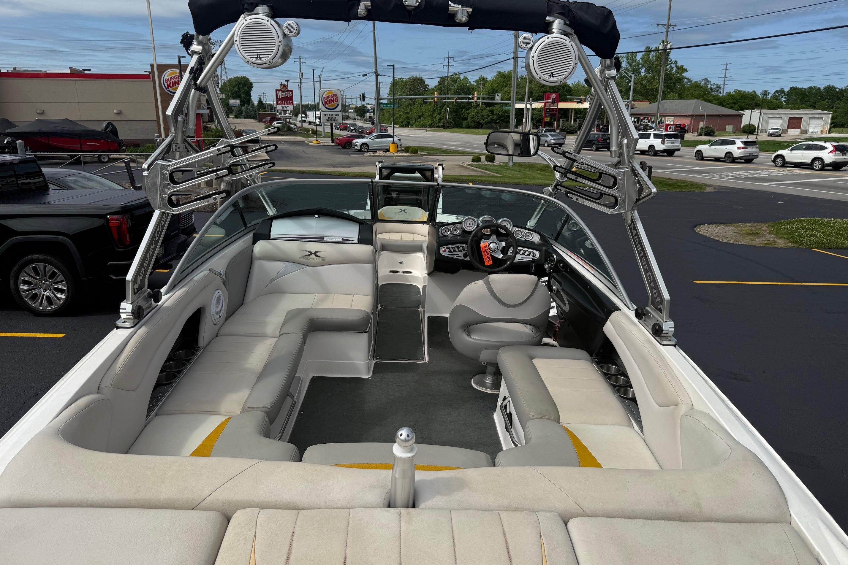 2008 MasterCraft X-15 boat interior with seating and wakeboard tower in a parking lot.