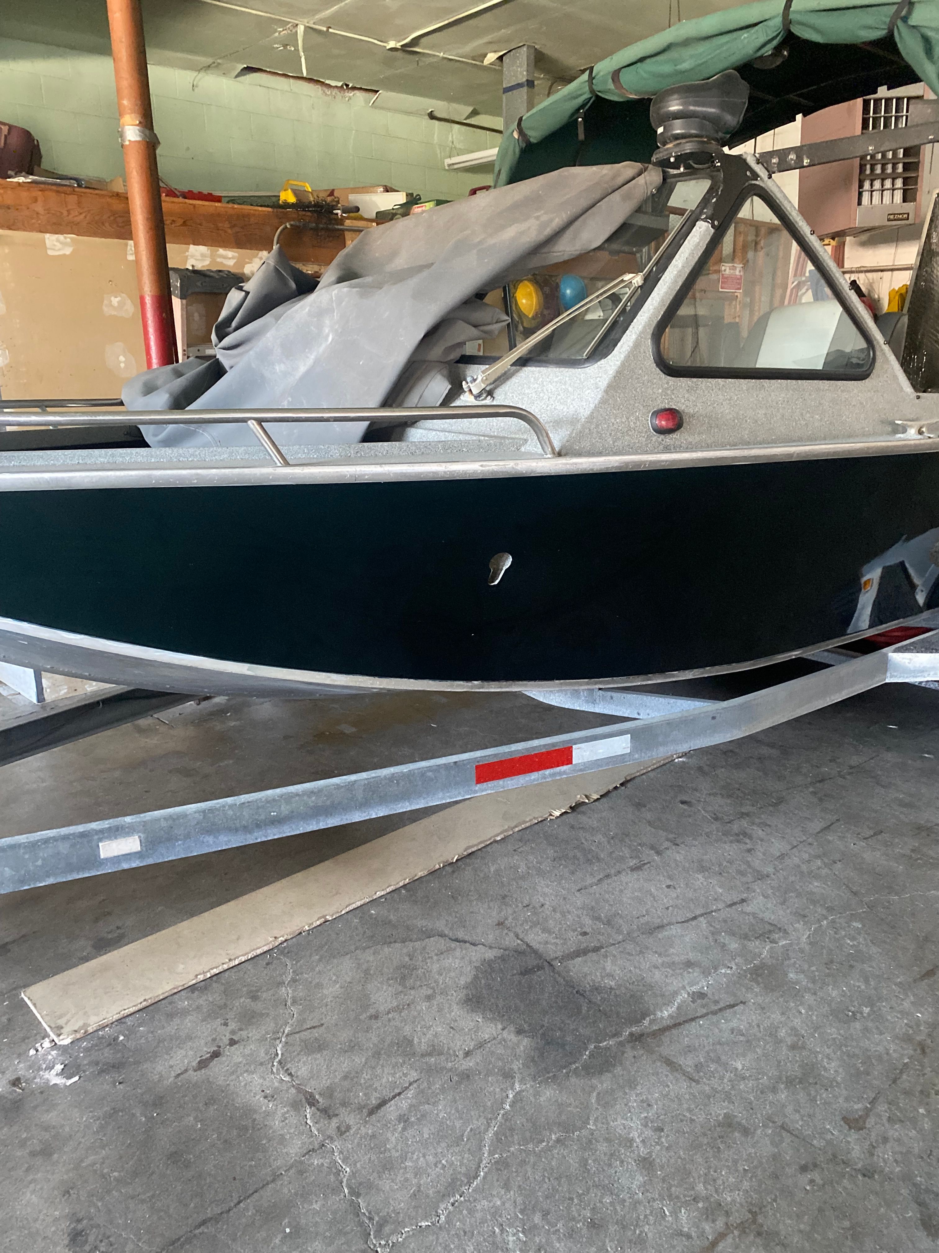 1993 Jetcraft Fastwater boat on trailer in garage.