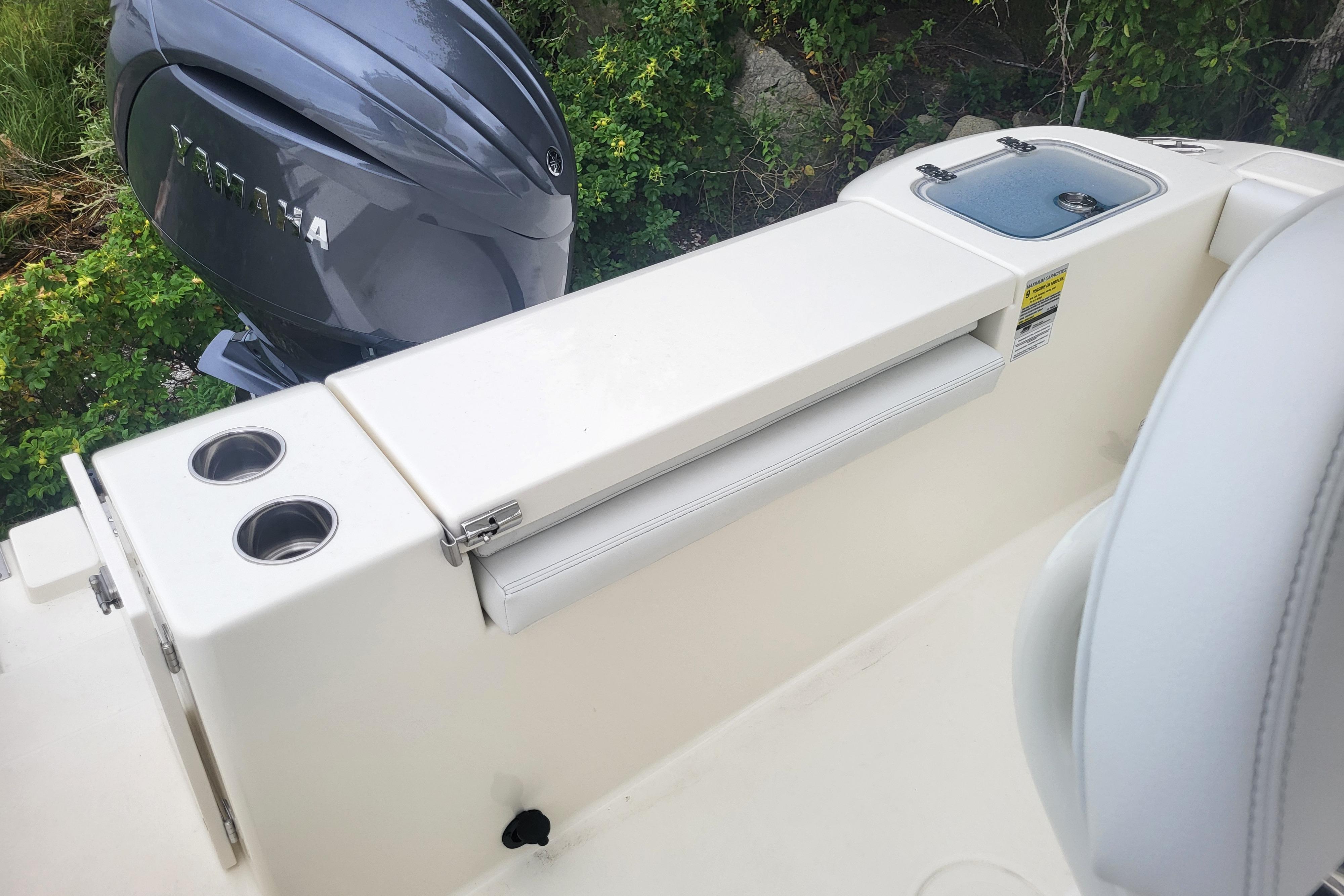 2025 Cobia 220 Center Console boat with Yamaha engine and cup holders.