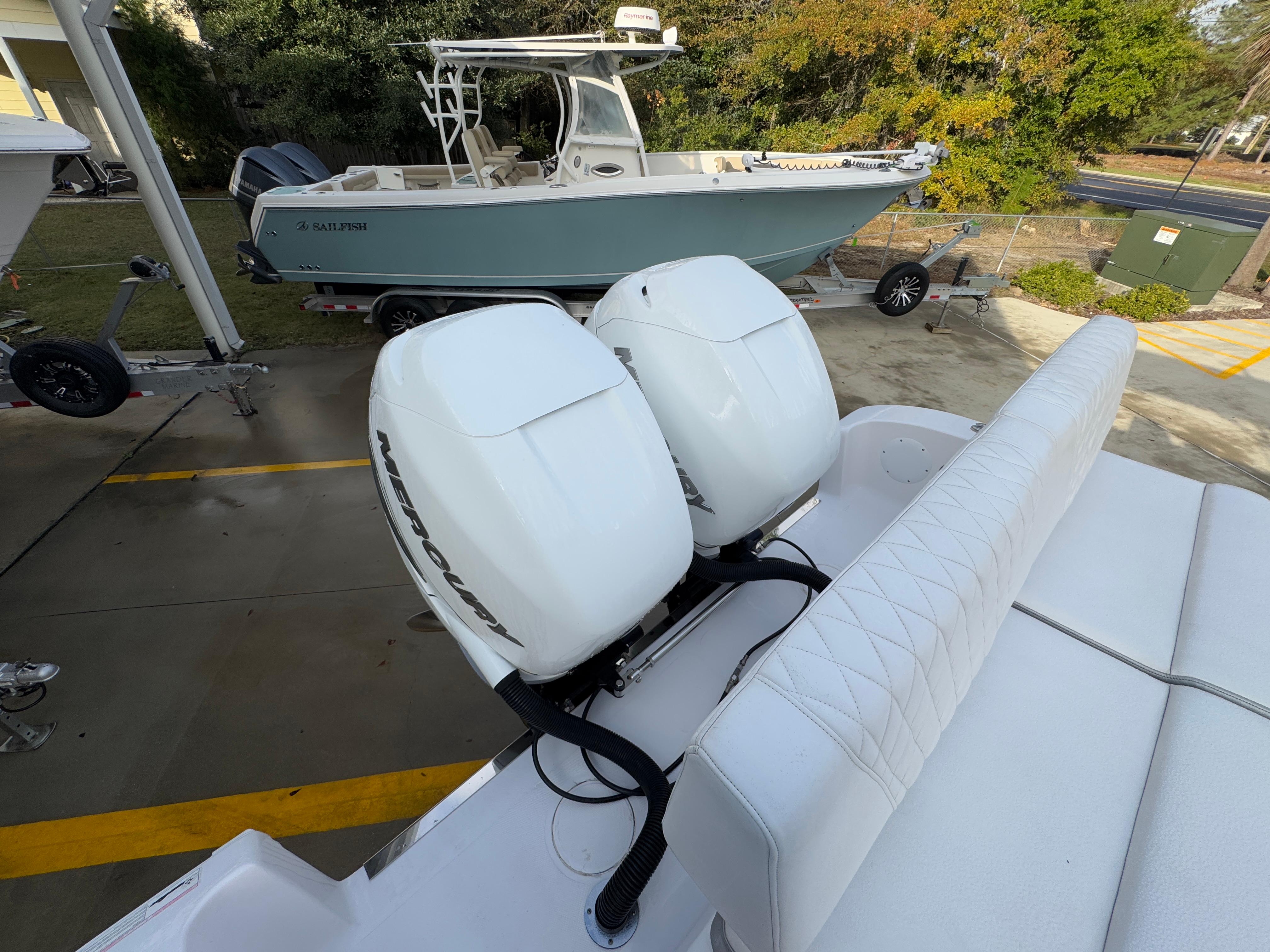 2018 Fountain 34 CC boat with twin Mercury outboard engines, parked on a trailer.