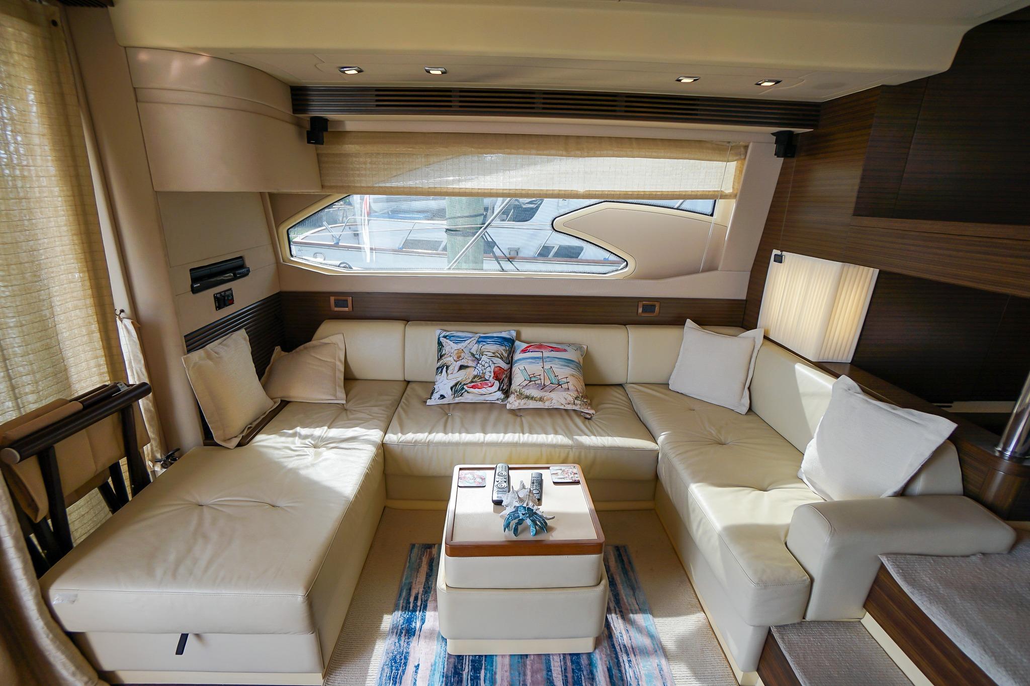 Luxurious interior of 2014 Azimut 54 Flybridge yacht with plush seating and elegant decor.