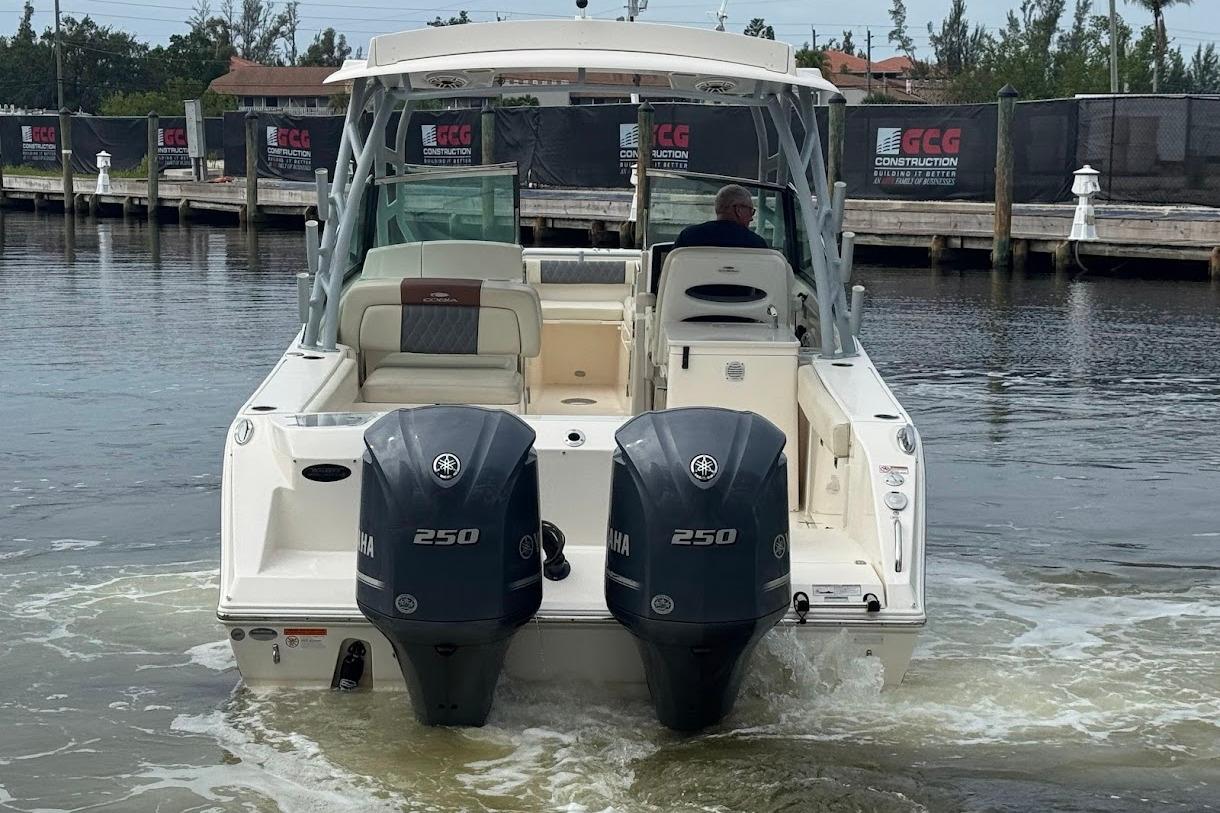 2020 Cobia 280 Dual Console boat with twin Yamaha 250 engines on water.