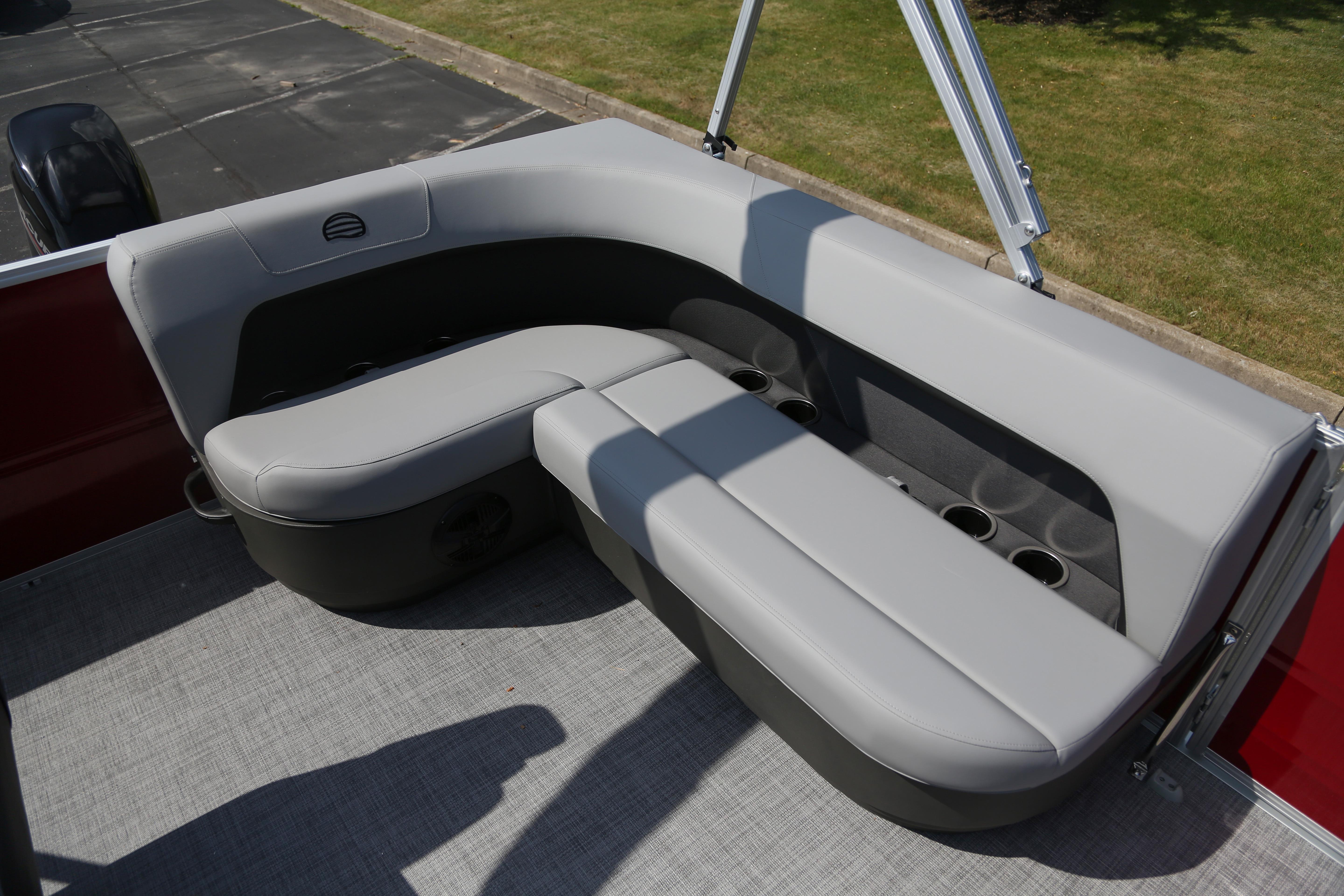 2026 Sun Tracker Party Barge 16 DLX, featuring comfortable gray seating with integrated cup holders.