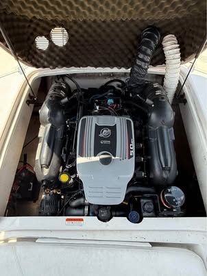 Engine compartment of a 2011 Tahoe 216 WT boat with open cover.