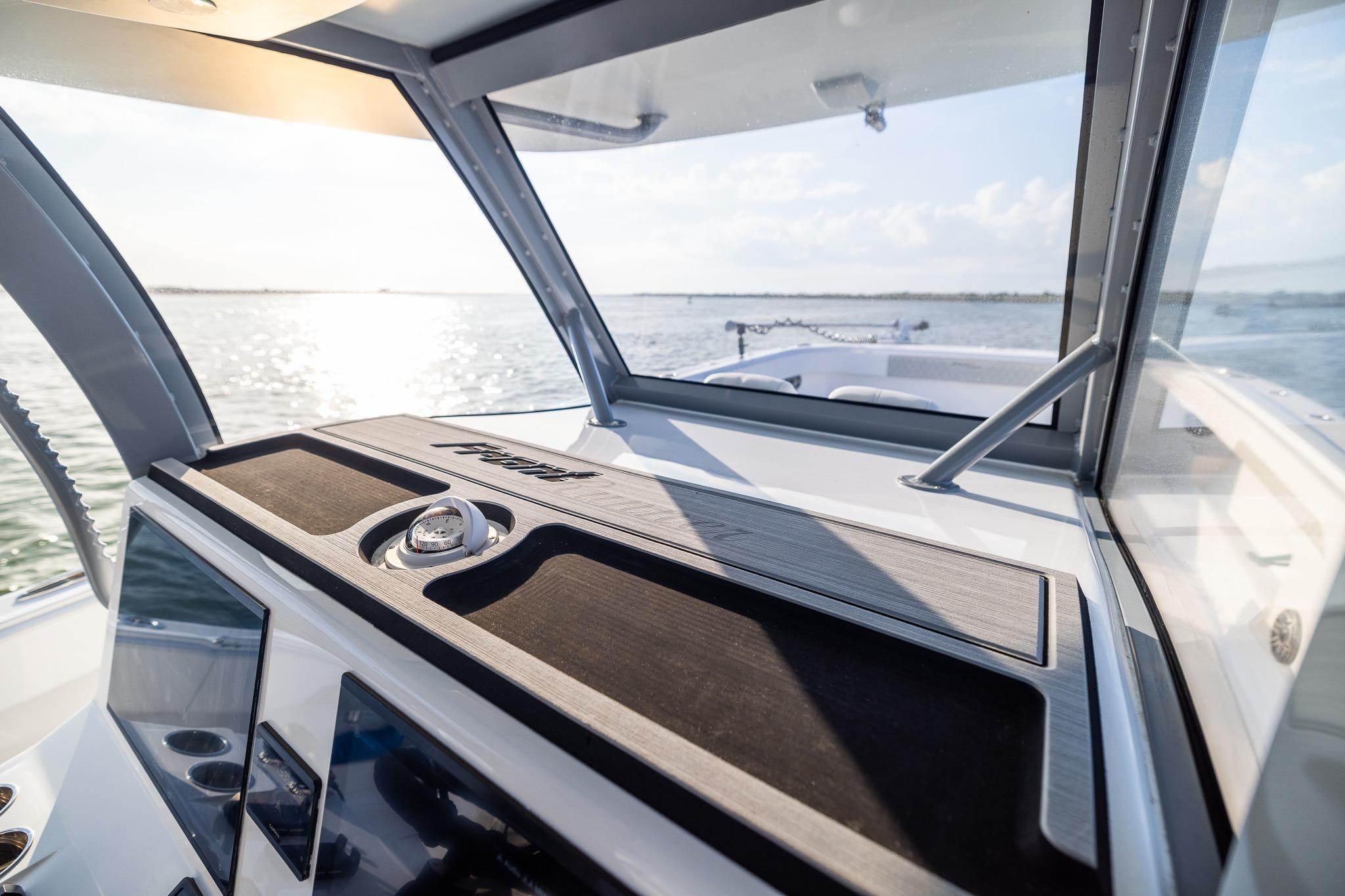 2026 Front Runner 37 Catamaran cockpit with modern dashboard, overlooking serene waters.