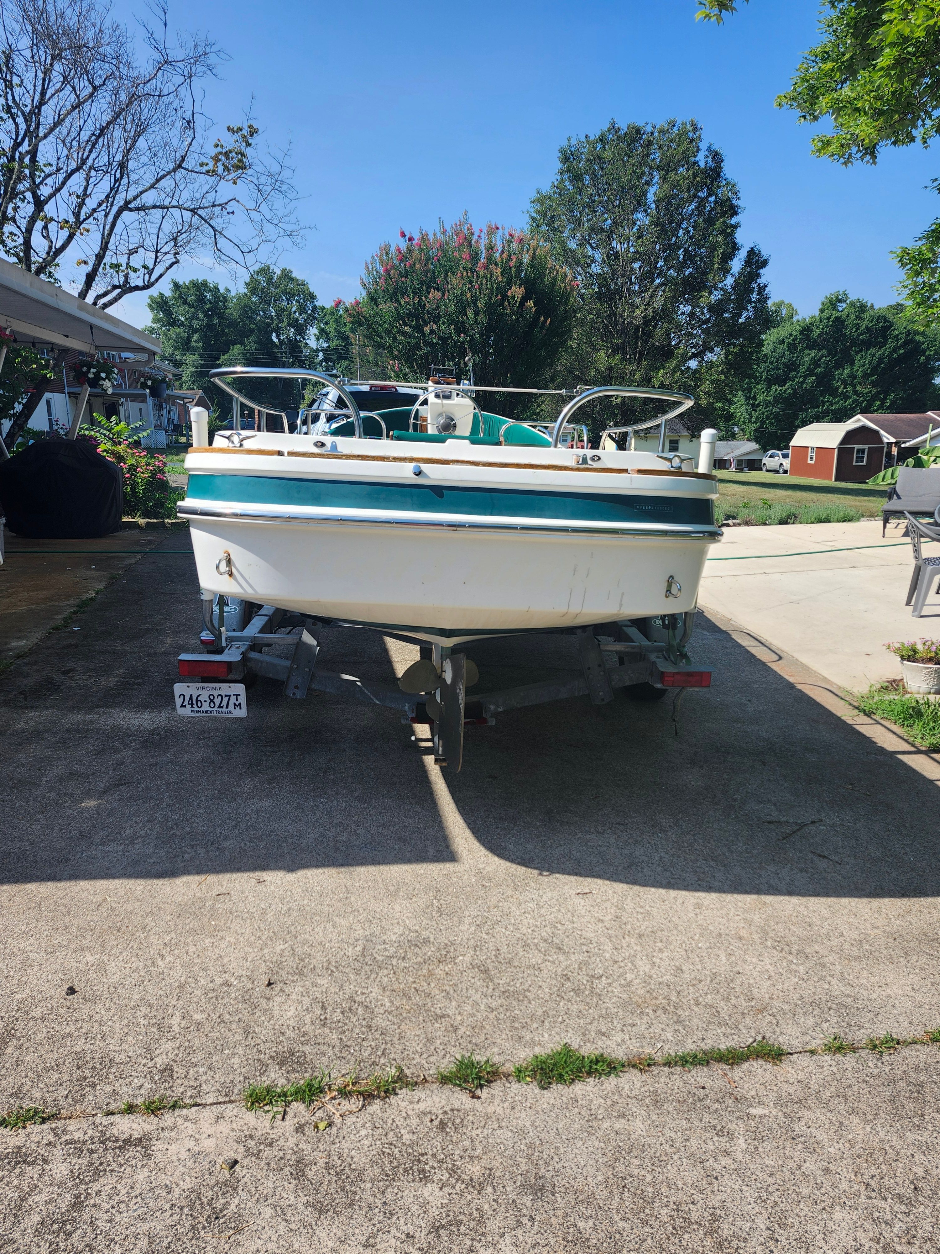 A 2000 Ranger Tugs Martini 21 Launch on a trailer in a driveway.