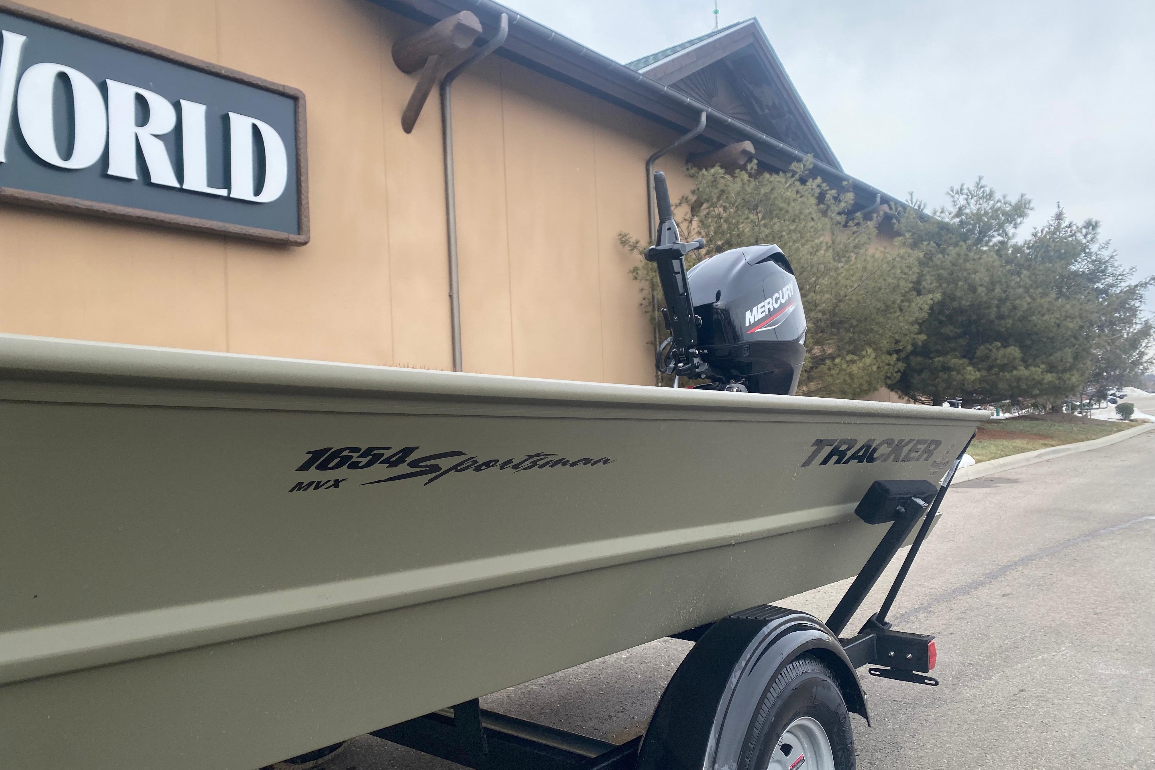2026 Tracker Grizzly 1654 T Sportsman boat with Mercury engine, parked outdoors.
