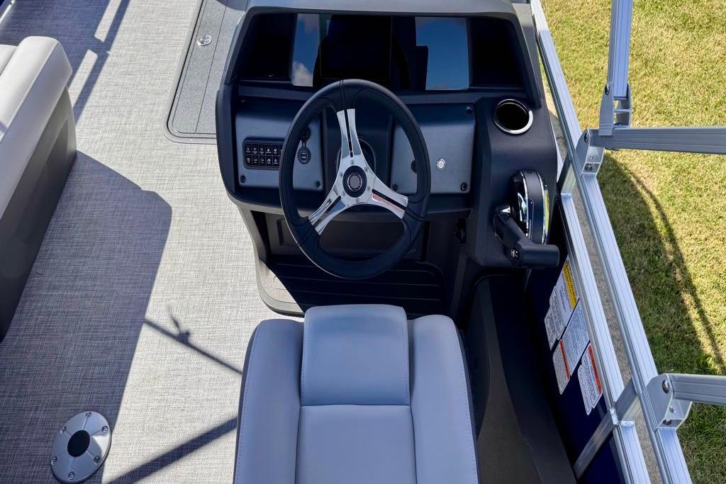 2026 Sun Tracker Sportfish 24 XP3 boat helm with steering wheel and controls.