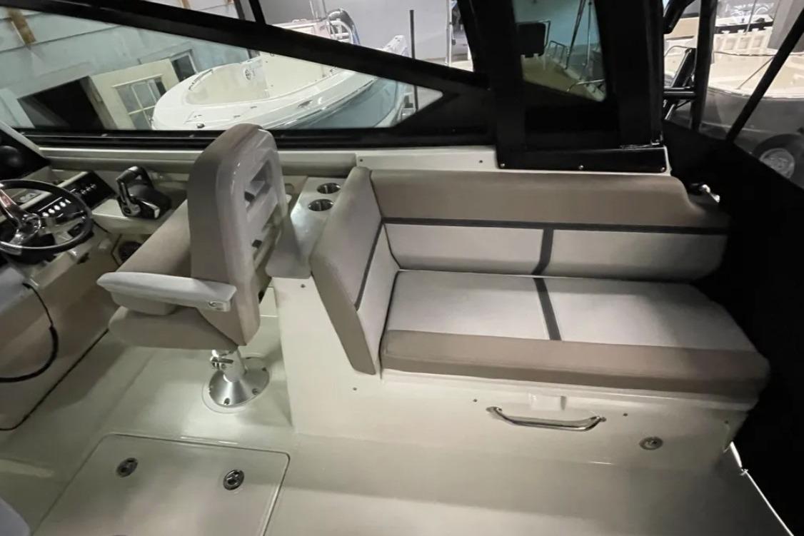 Interior of 2025 Boston Whaler 330 Vantage boat, featuring seating and helm area.