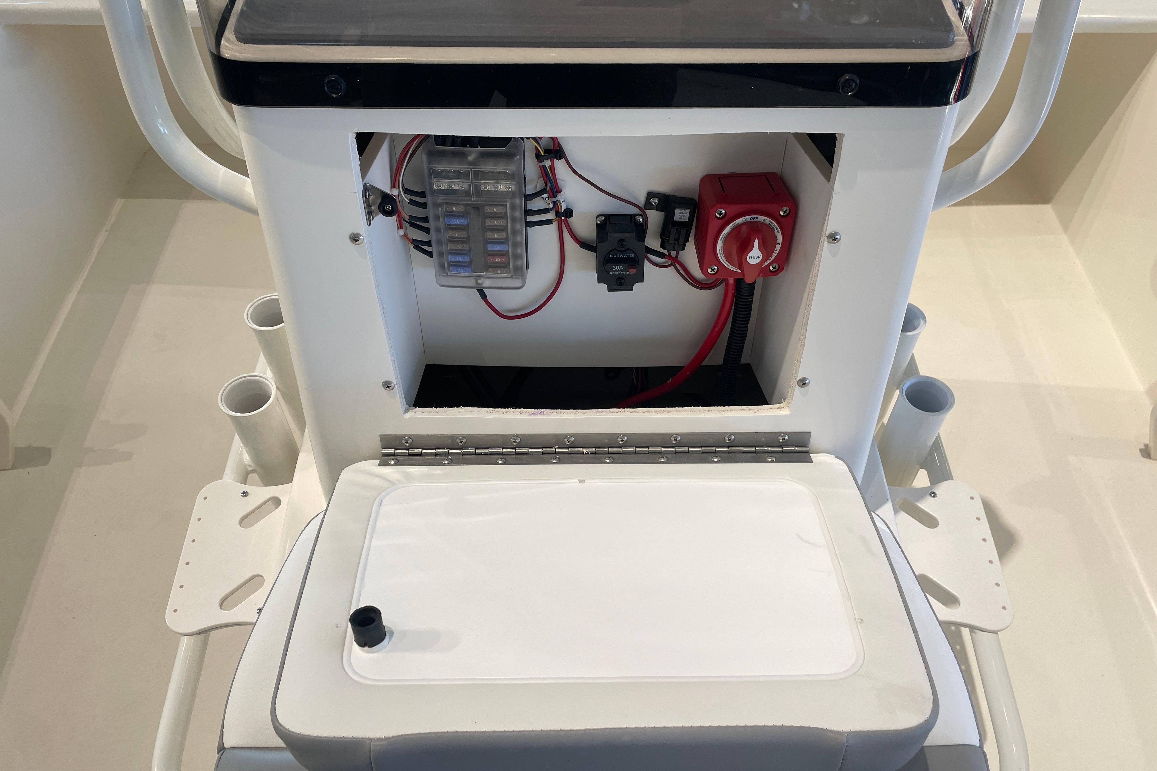 2026 Mako 18 Pro Skiff console with open storage compartment and electrical components.