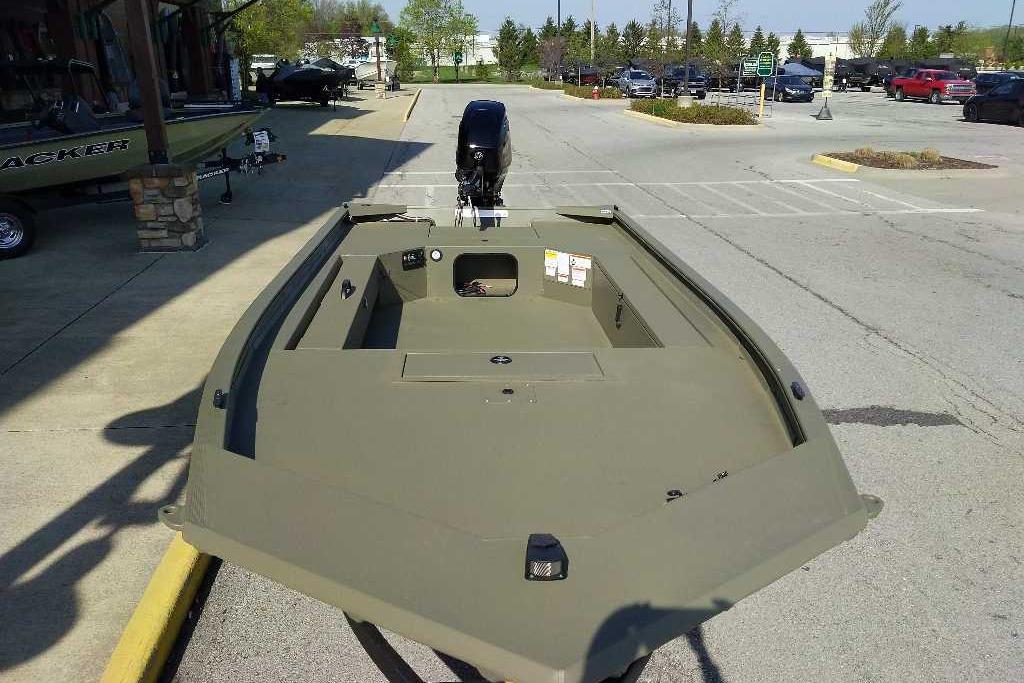 2026 Tracker Grizzly 1654 T Sportsman boat in a parking lot, showcasing its sleek design.