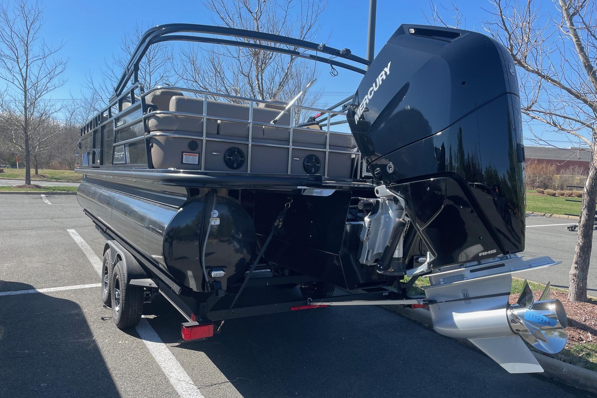 2024 Ranger 2500LS pontoon boat with Mercury outboard engine in a parking lot.