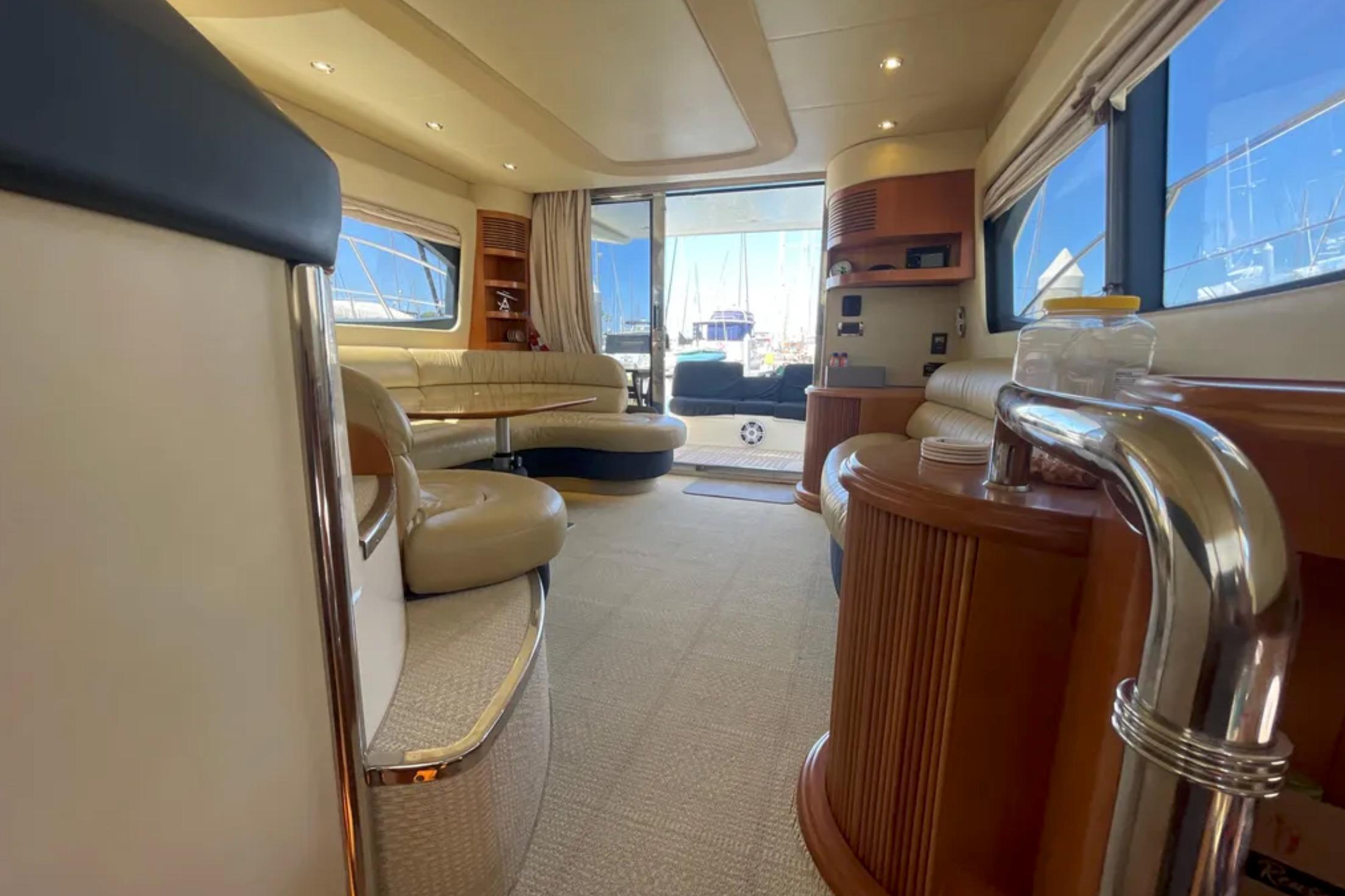 Luxurious interior of a 2004 Azimut 46 yacht with elegant seating and panoramic windows.