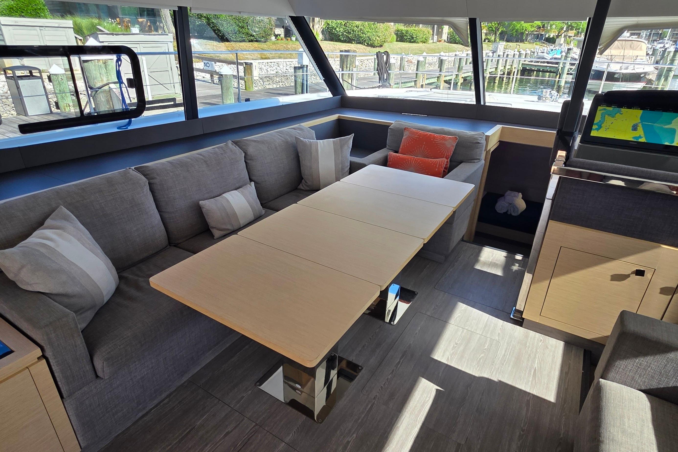 Luxurious interior of 2018 Fountaine Pajot Motor Yacht 44 with modern seating and table.