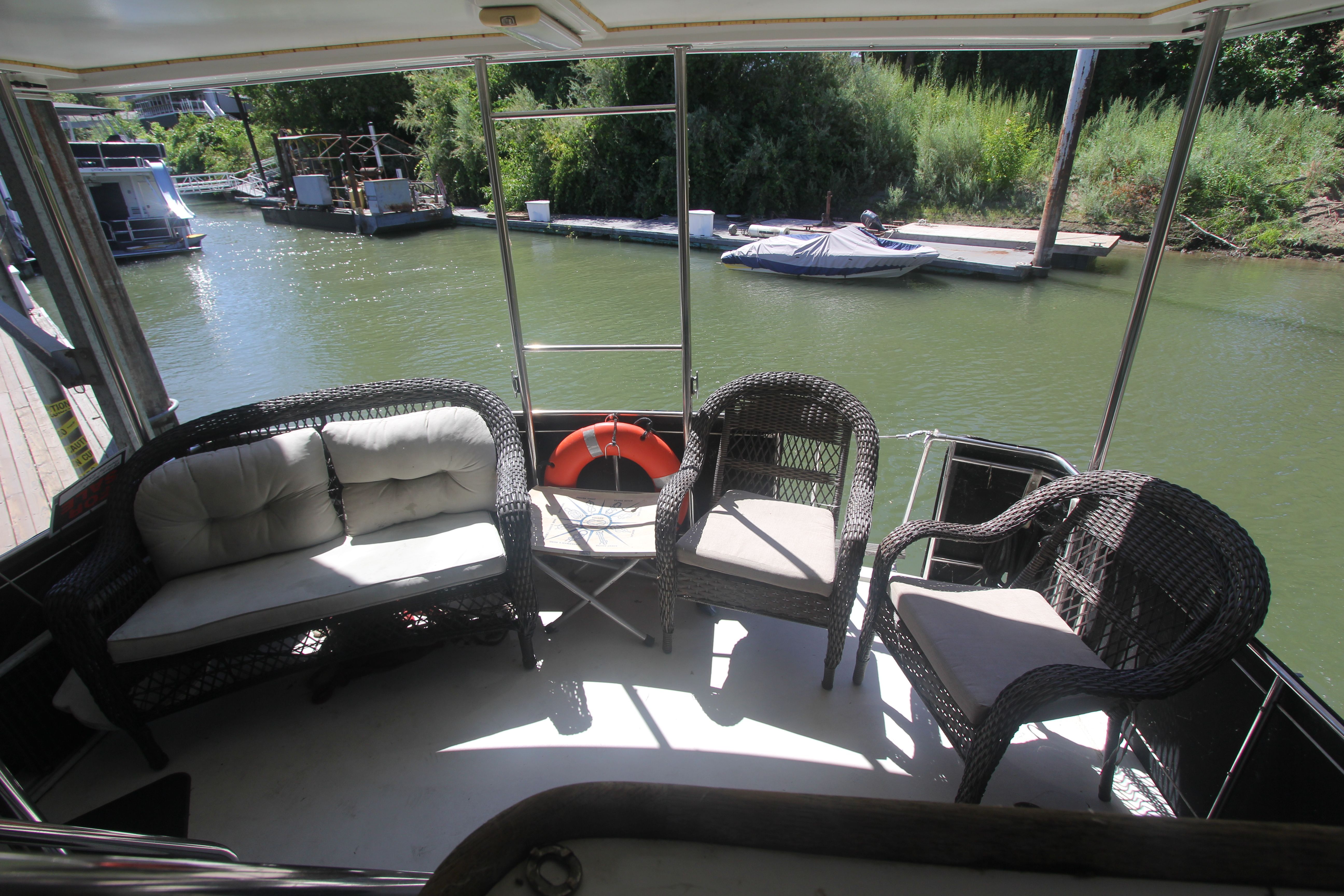 1988 Carver 3607 Aft Cabin Motor Yacht with a cozy seating area by the water.