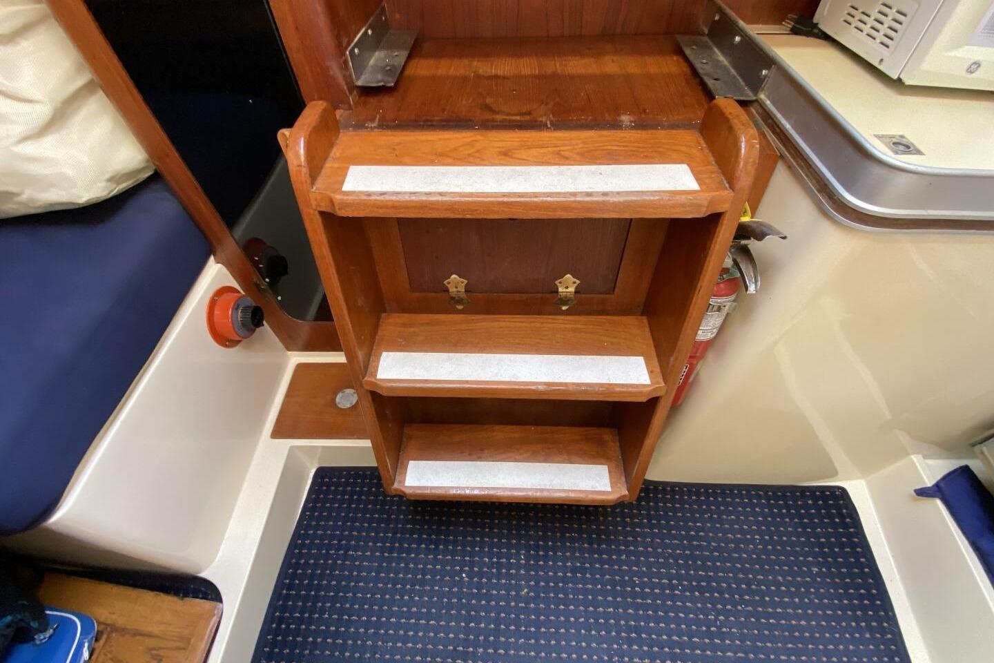 Wooden steps with anti-slip strips in a 1980 CS 36 Traditional sailboat interior.