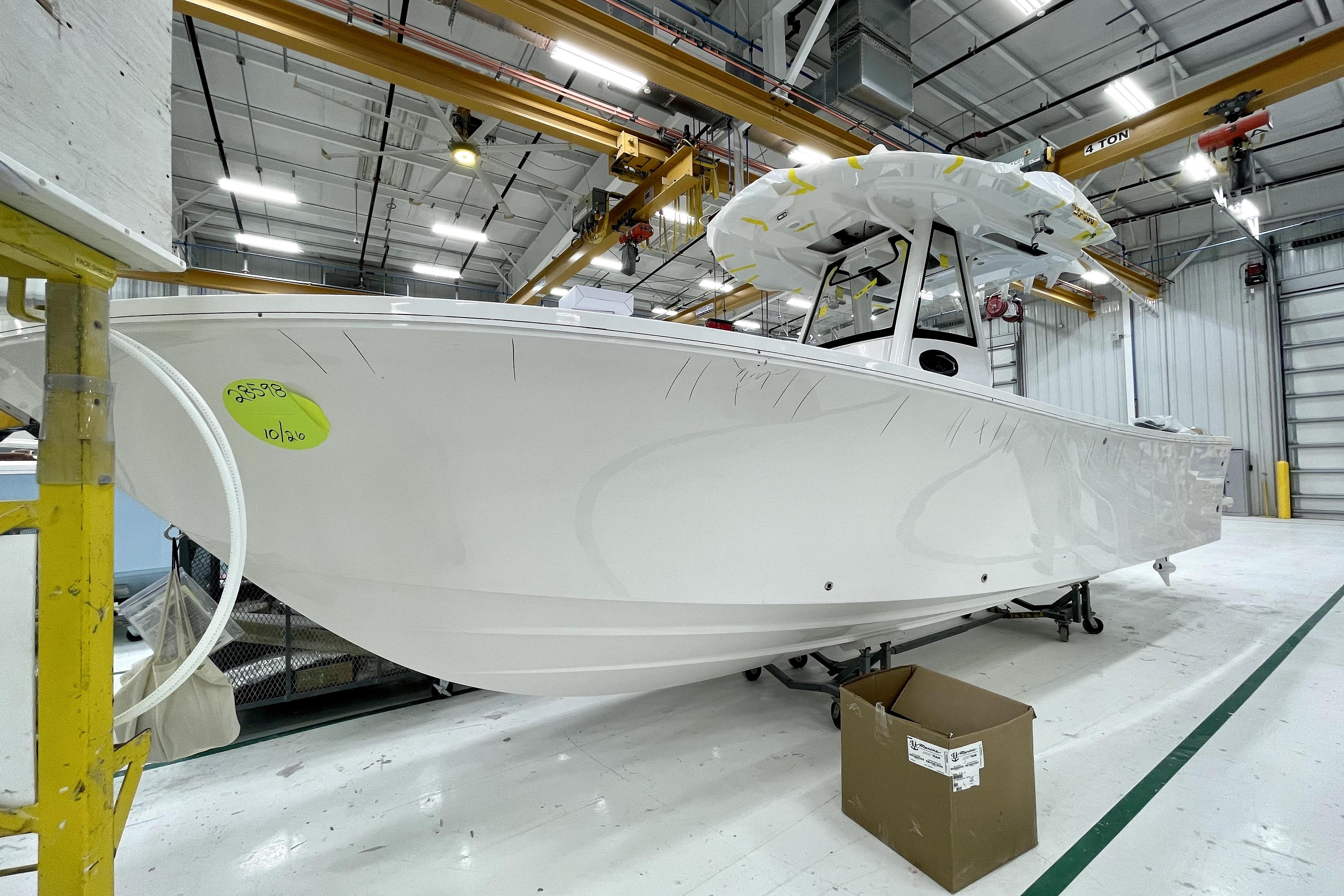 2022 Regulator 28 boat in a manufacturing facility, under bright industrial lighting.