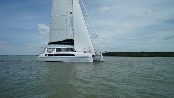 2025 Seawind 1160 XL catamaran sailing on calm waters under a clear sky.