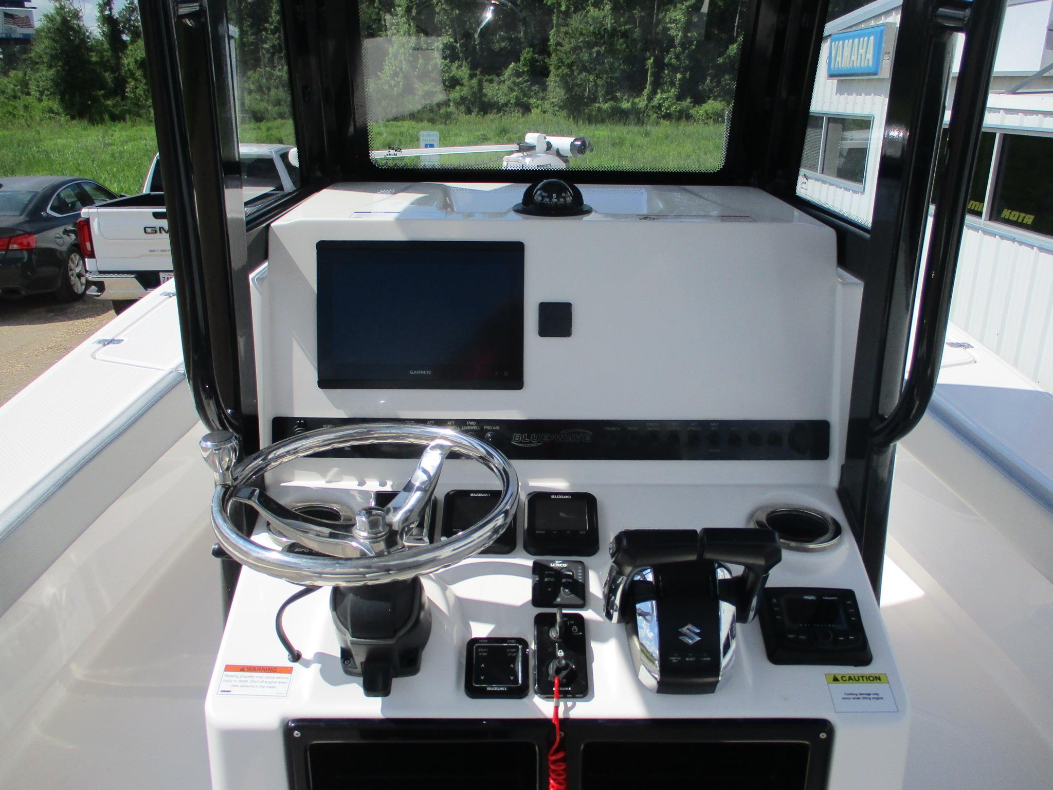 2024 Blue Wave 2800 Makaira boat console with steering wheel and navigation controls.