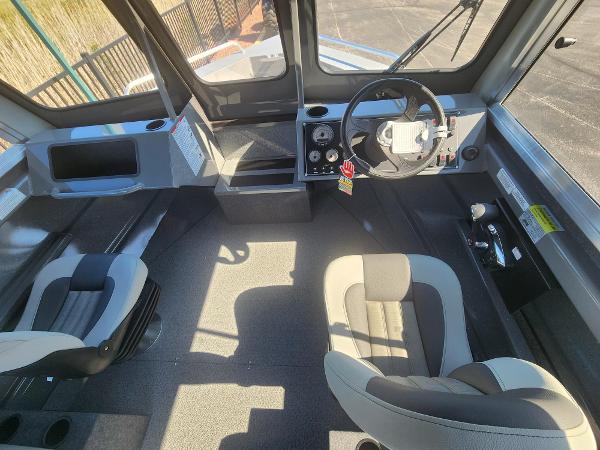 Interior of 2025 Spartan 200 Astoria boat with modern seating and control panel.