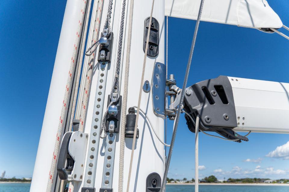 Close-up of a 2008 Discovery 55 sailboat mast and rigging against a clear blue sky.