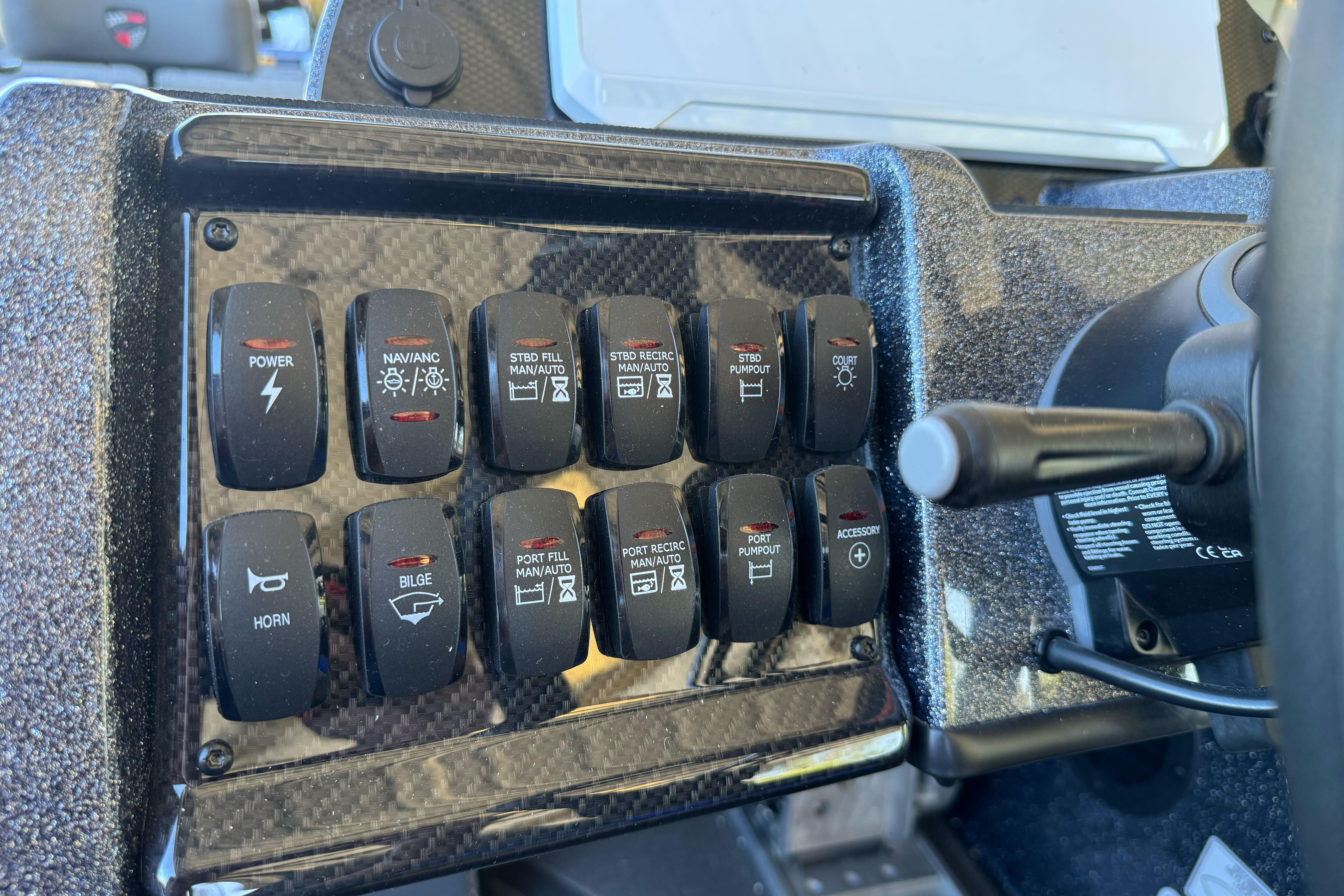 Dashboard controls of a 2026 Triton 21XP Patriot boat, featuring various switches.