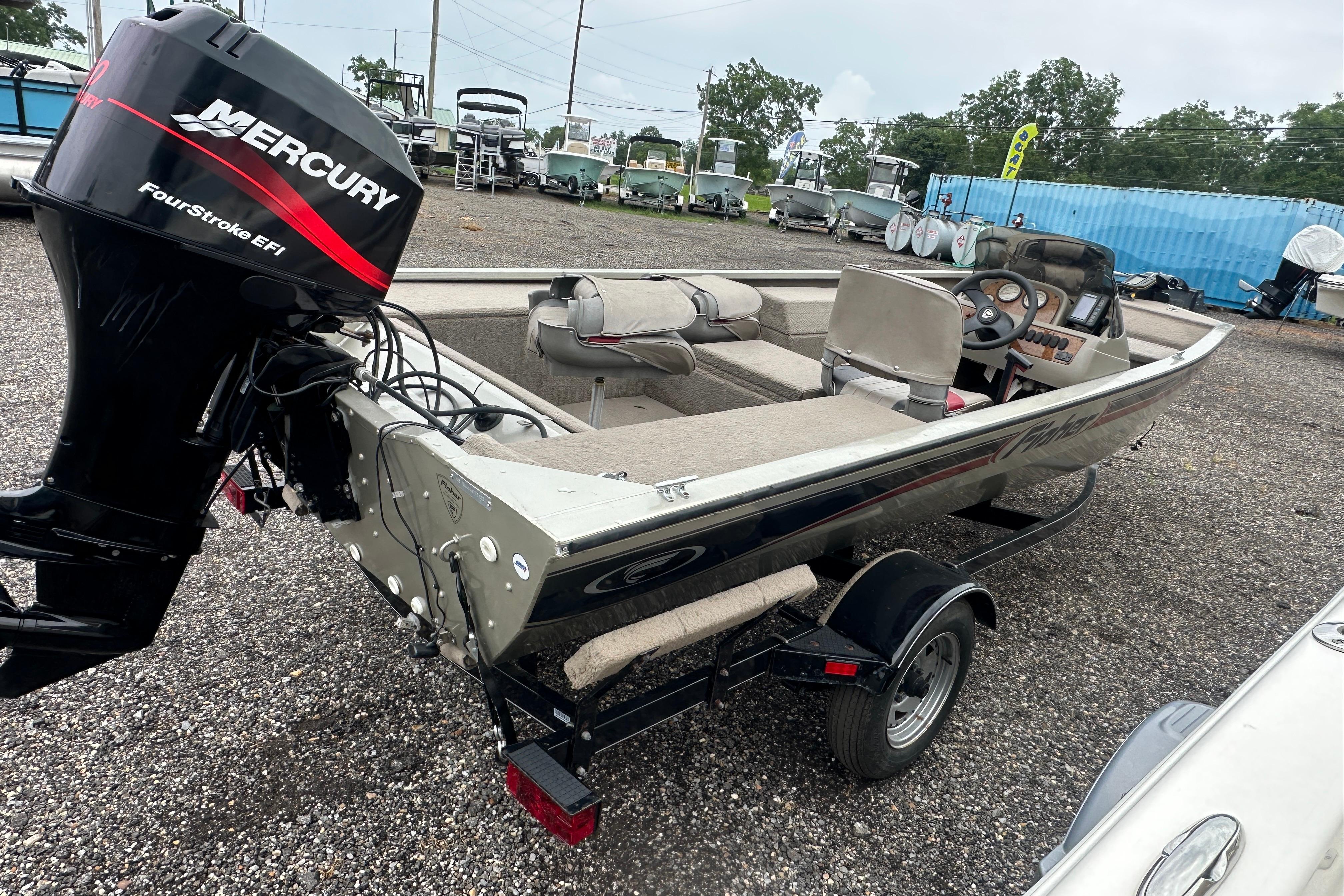 2002 Fisher 1710 boat with Mercury FourStroke EFI engine on trailer.