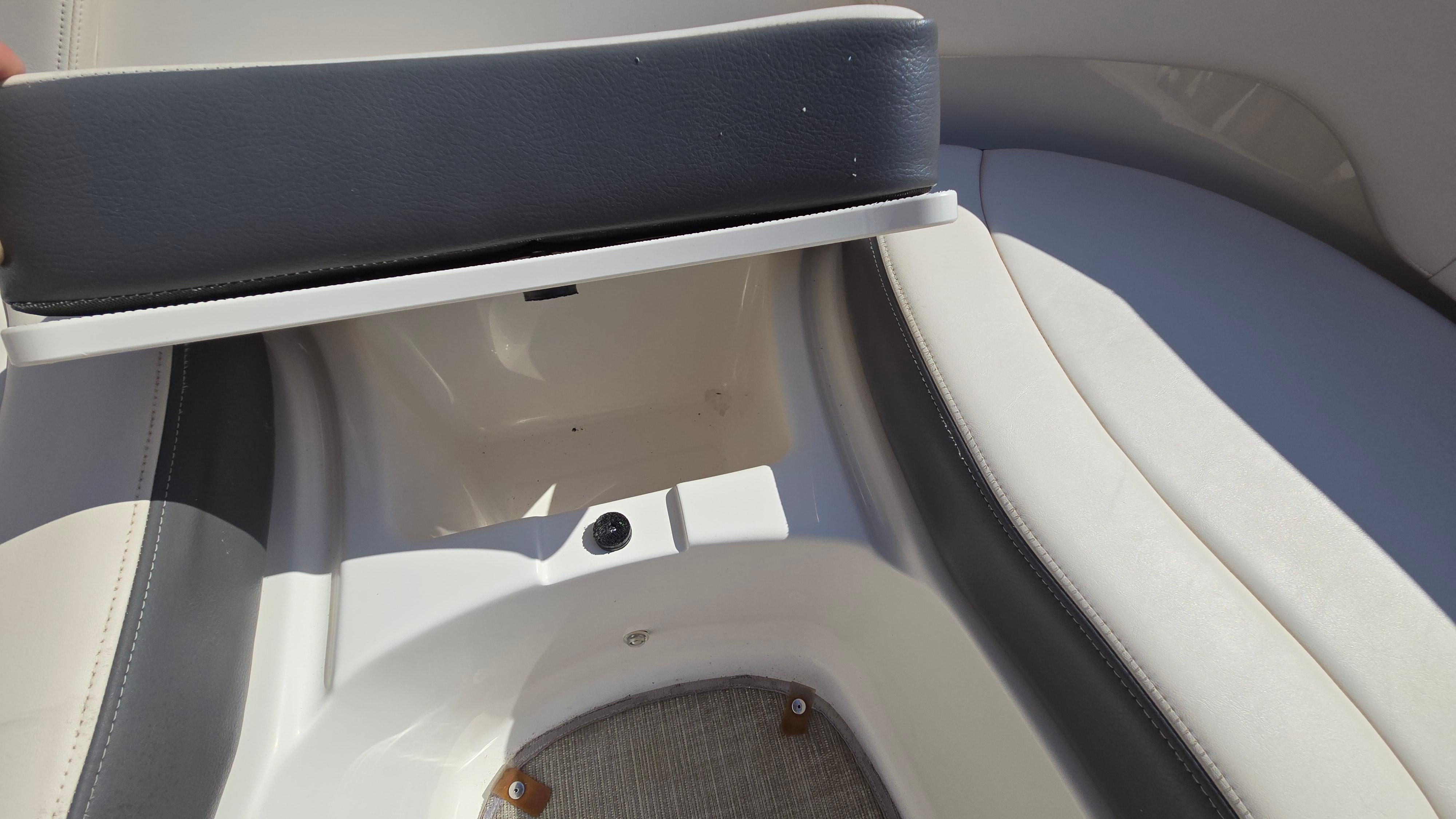 2018 Chaparral 224 Sunesta boat seat storage compartment open.