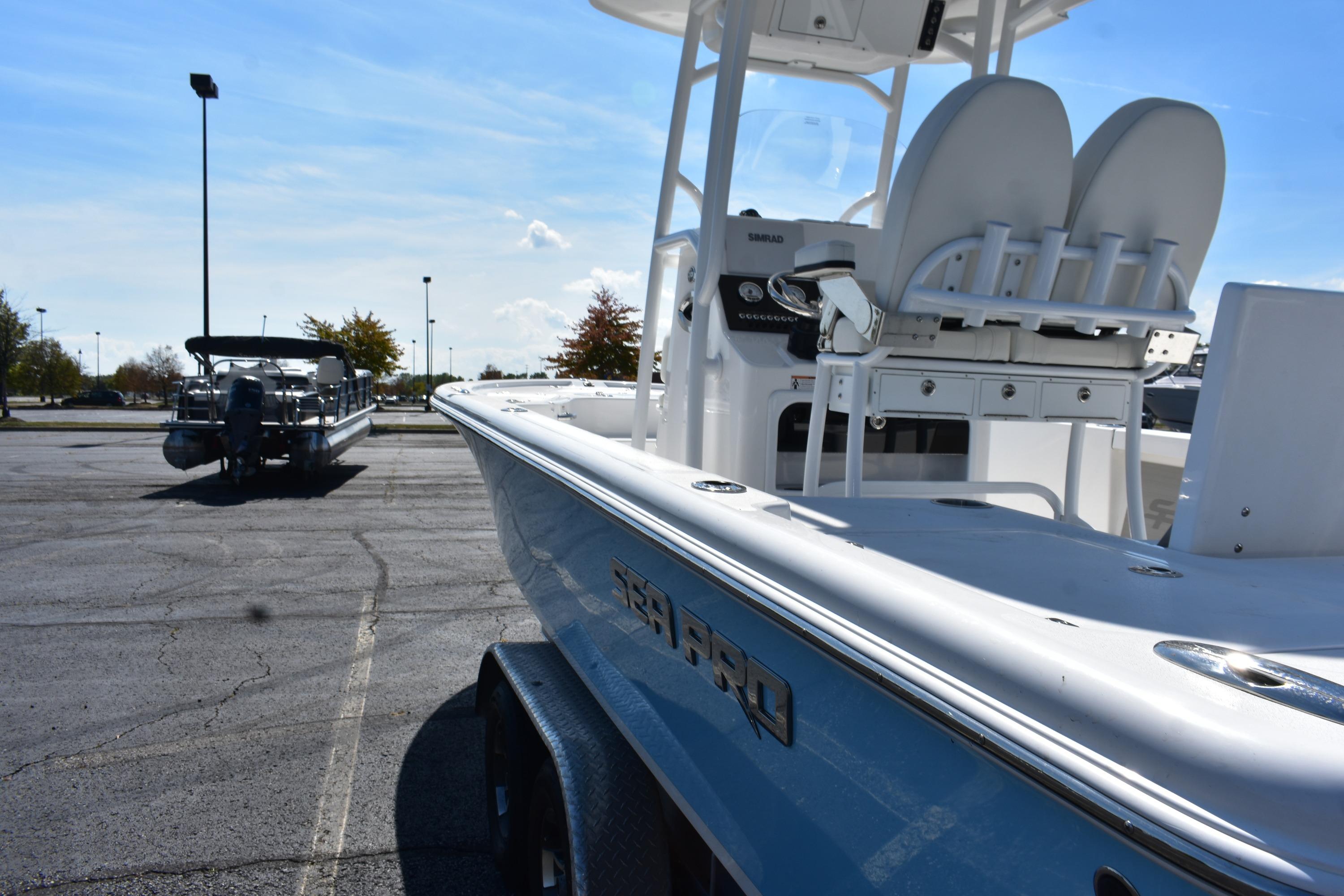 2025 Sea Pro 230 Bay boat parked in a lot under a clear blue sky.