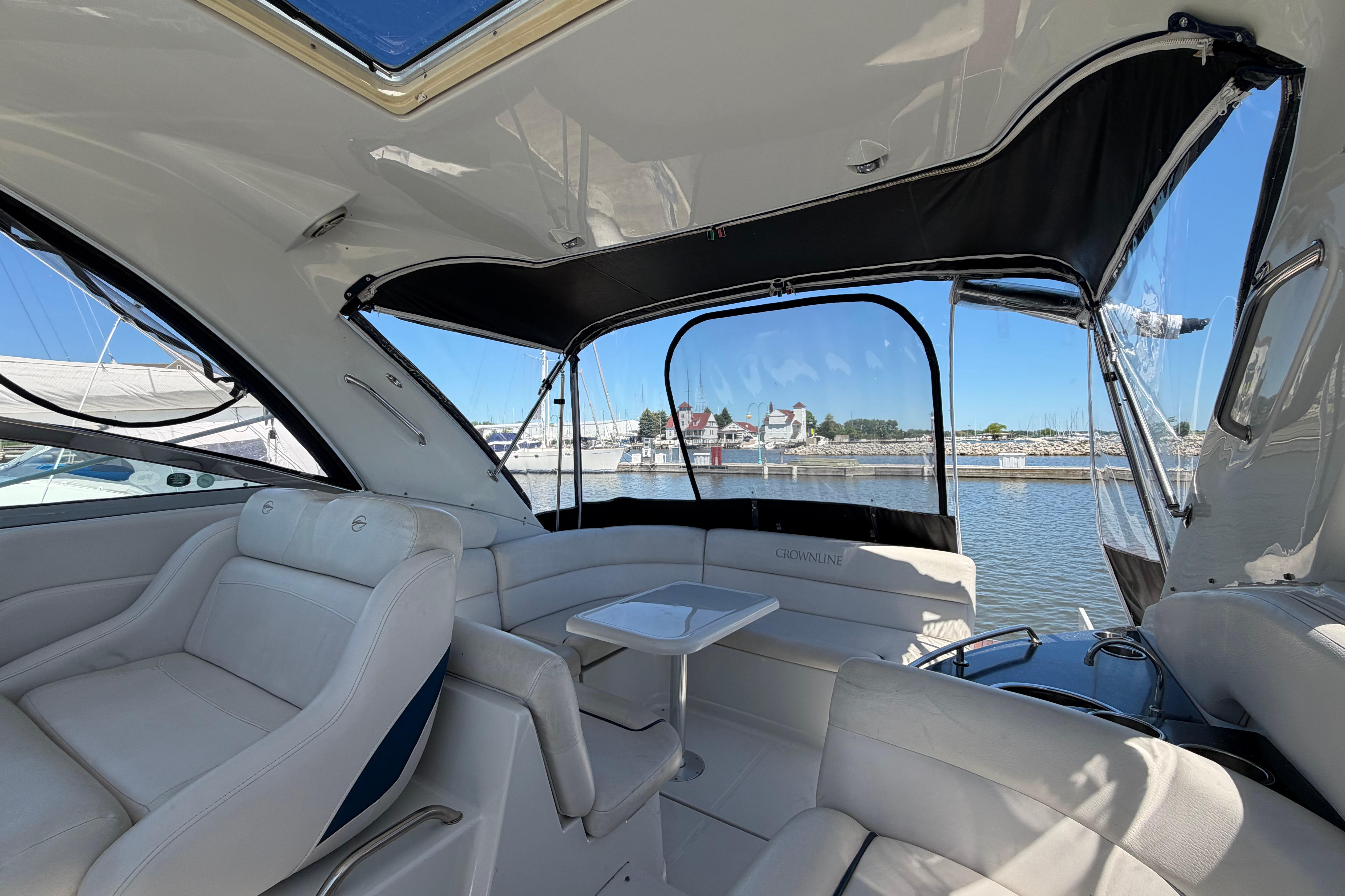 Interior view of 2008 Crownline 340 CR yacht with luxurious seating and marina backdrop.