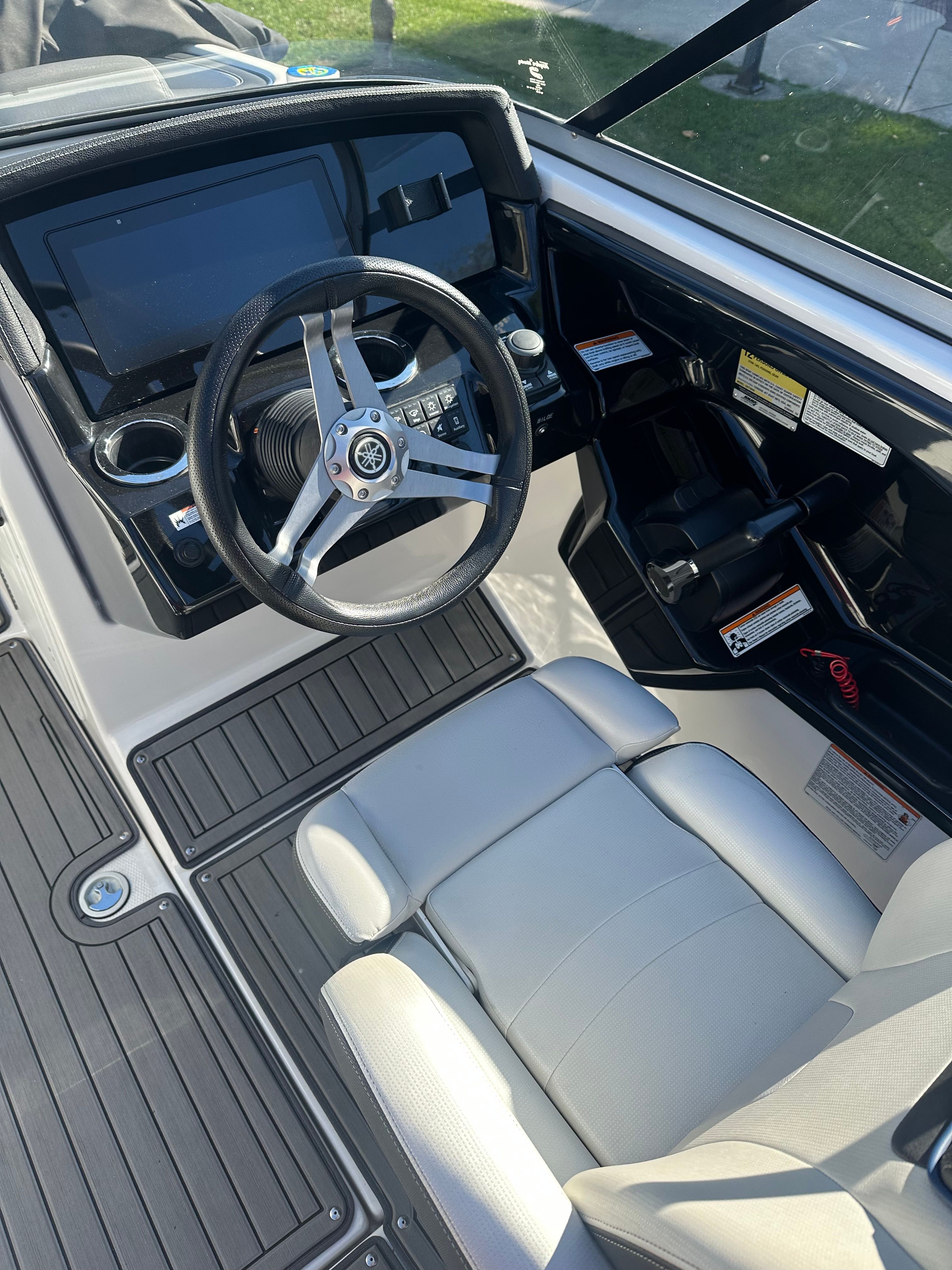 The image shows the cockpit of a 2018 Yamaha 242 Limited S boat with a modern helm.