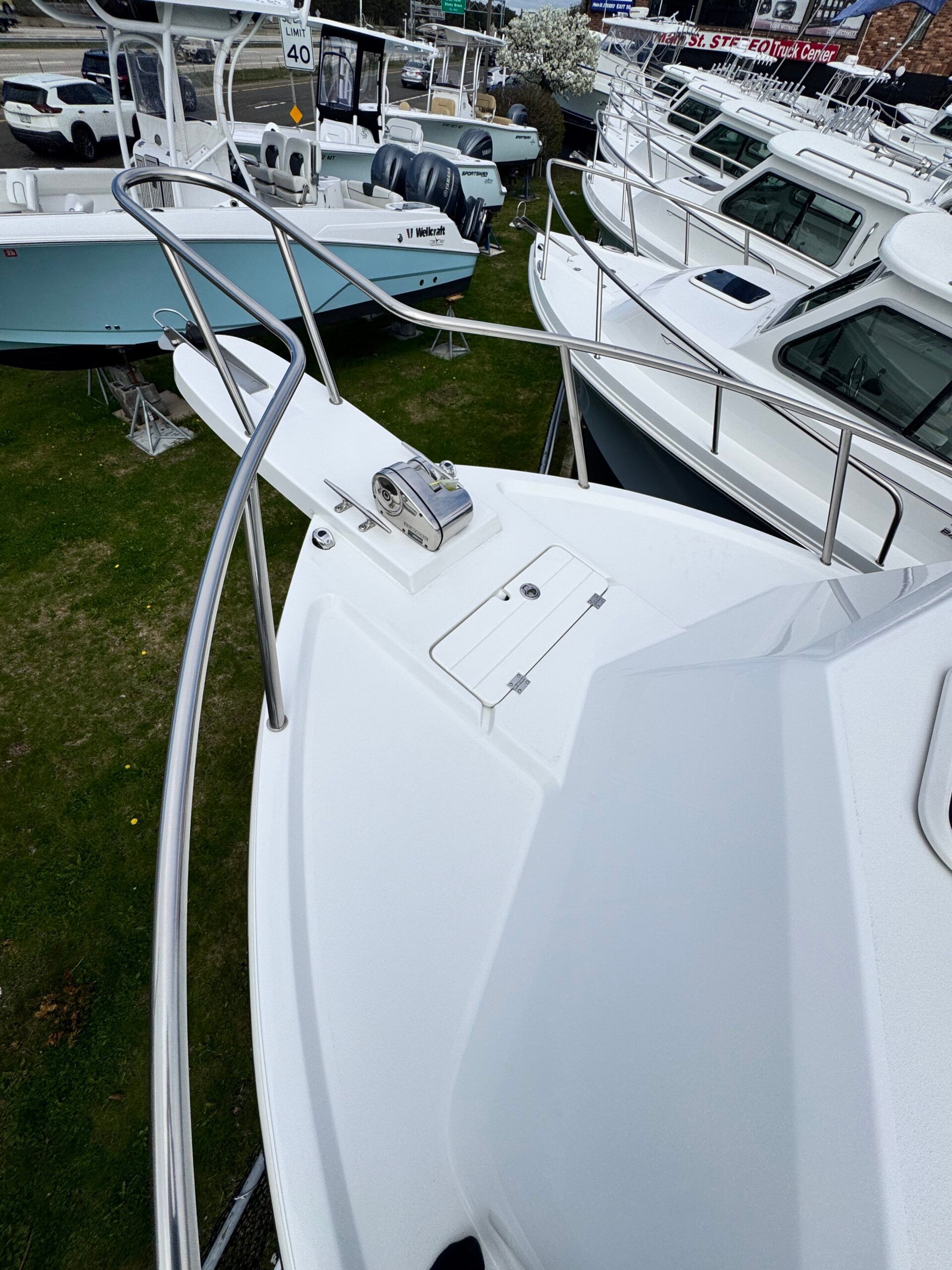The image shows the bow of a 2021 Regal 26 Express boat on grass.