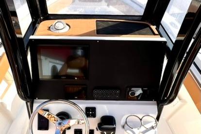 Helm of 2026 Key West 239 FSR boat with modern controls and steering wheel.