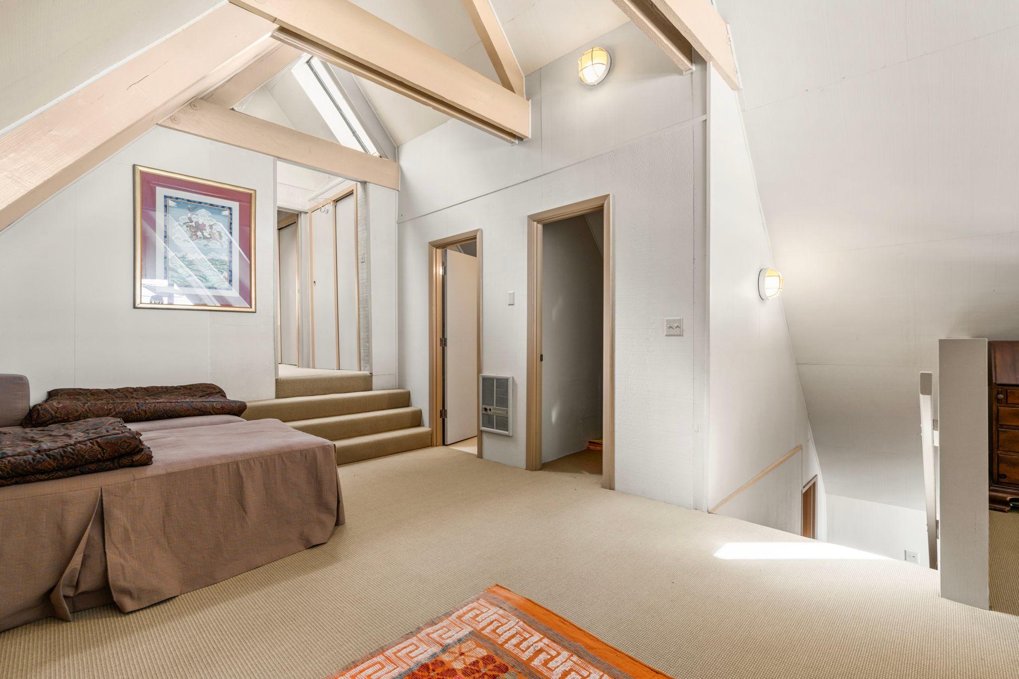 Spacious 1976 custom boathouse interior with vaulted ceilings and cozy seating area.