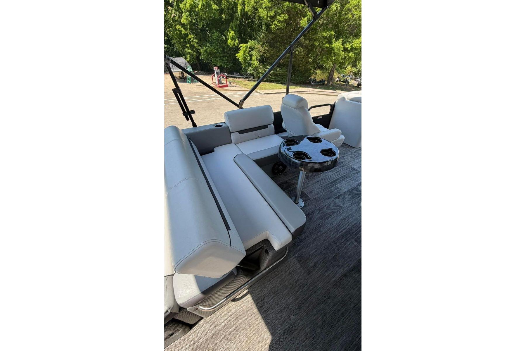 2023 Godfrey Sweetwater 2486 SFL boat interior with seating and cup holders.