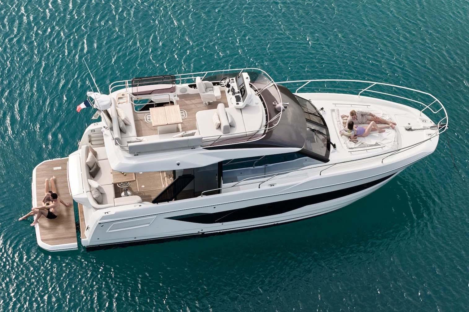 Manufacturer Provided Image: Luxury 2026 Prestige F4.3 yacht cruising on clear blue waters, with people relaxing onboard.