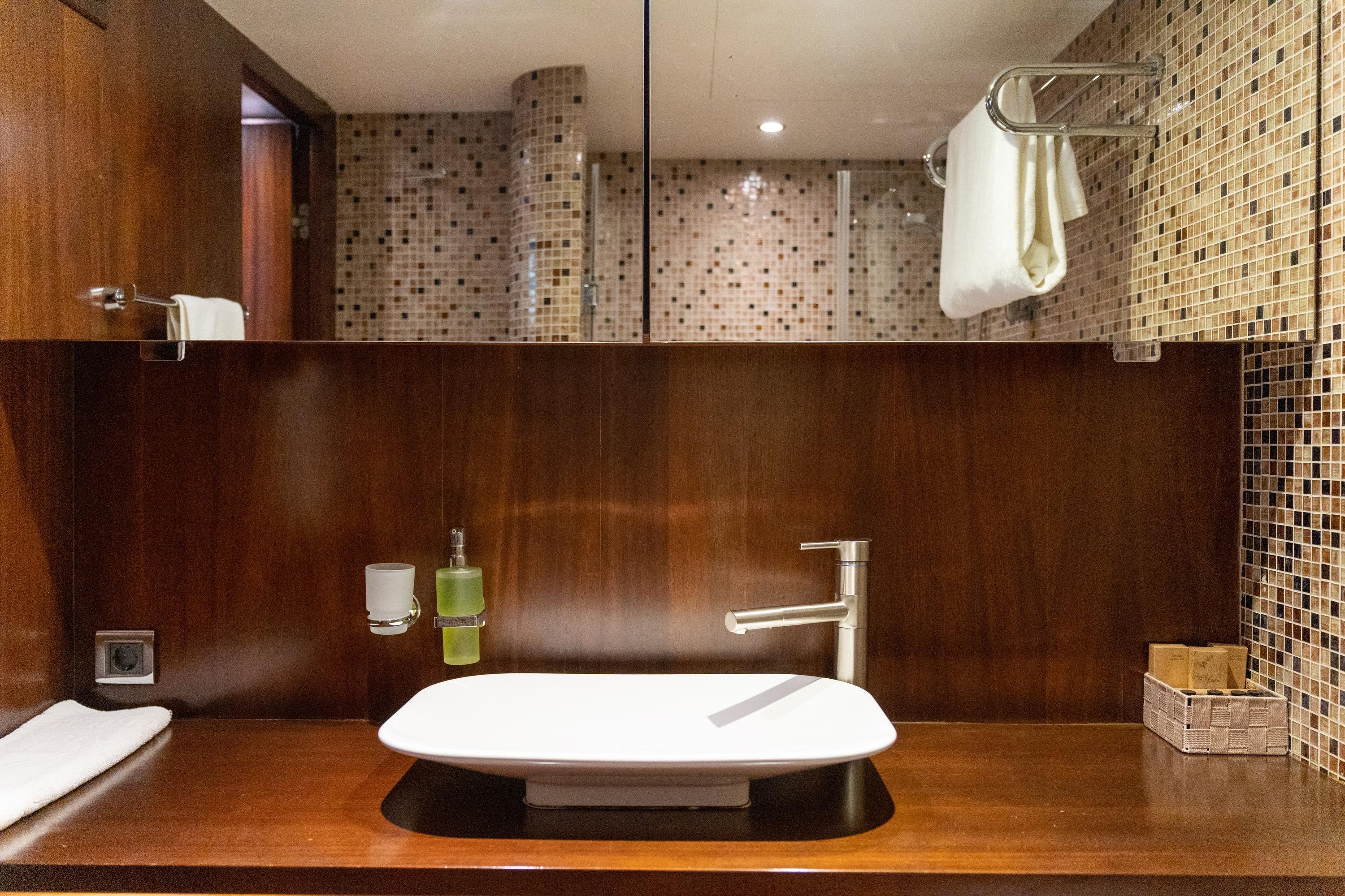Luxurious yacht bathroom with modern sink and mosaic tiles, Ada Yacht Ketch 2009.