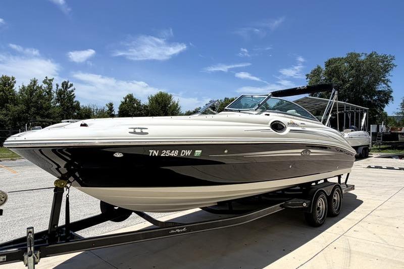2007 Sea Ray 240 Sundeck boat on trailer under clear blue sky.