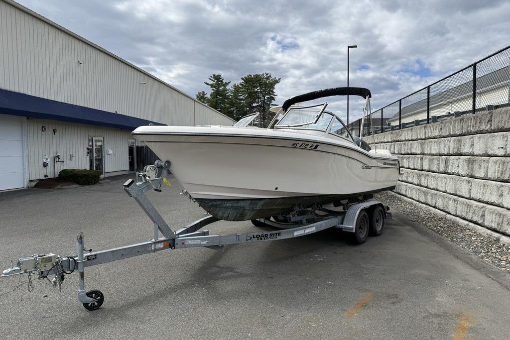 2019 Grady-White Freedom 215 boat on trailer, parked outdoors near a building.
